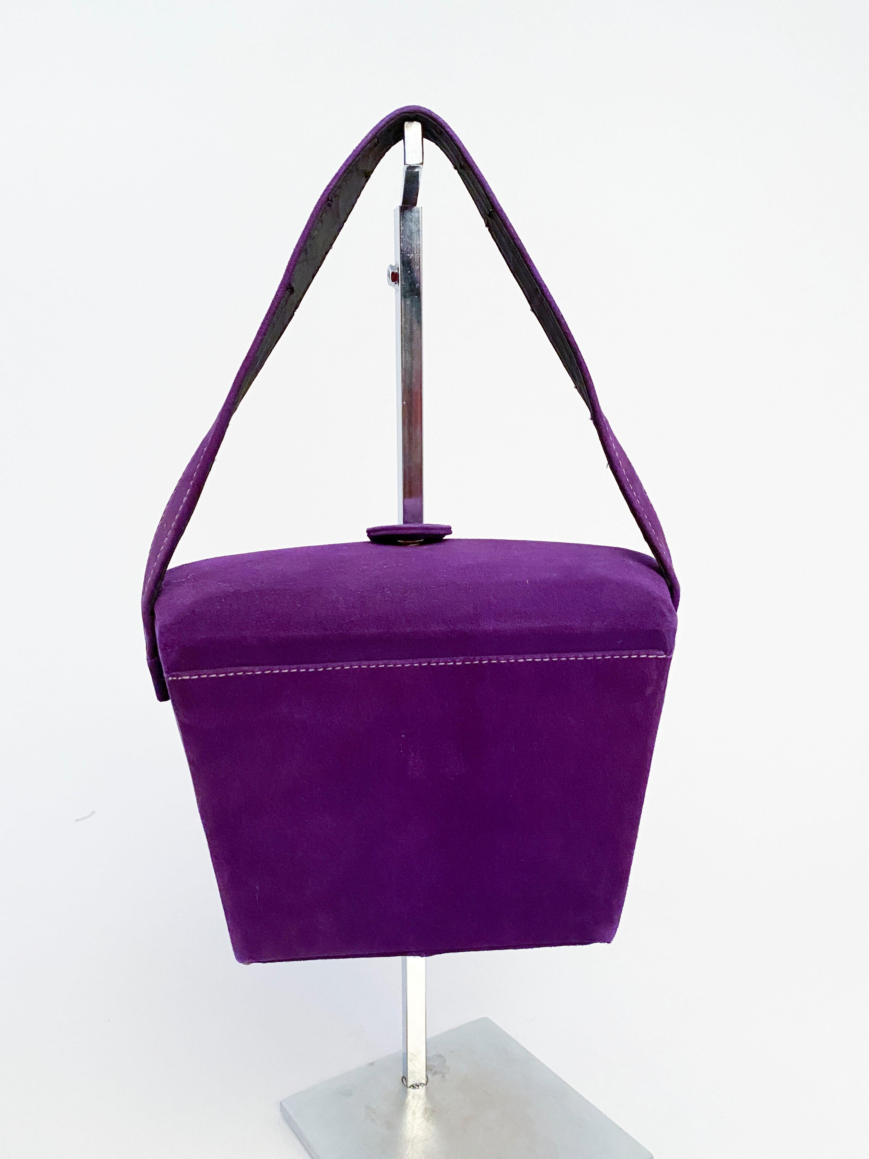 1950s French Perma-suede faux leather suede handbag in purple with snap closure, structured body, and brass feet.