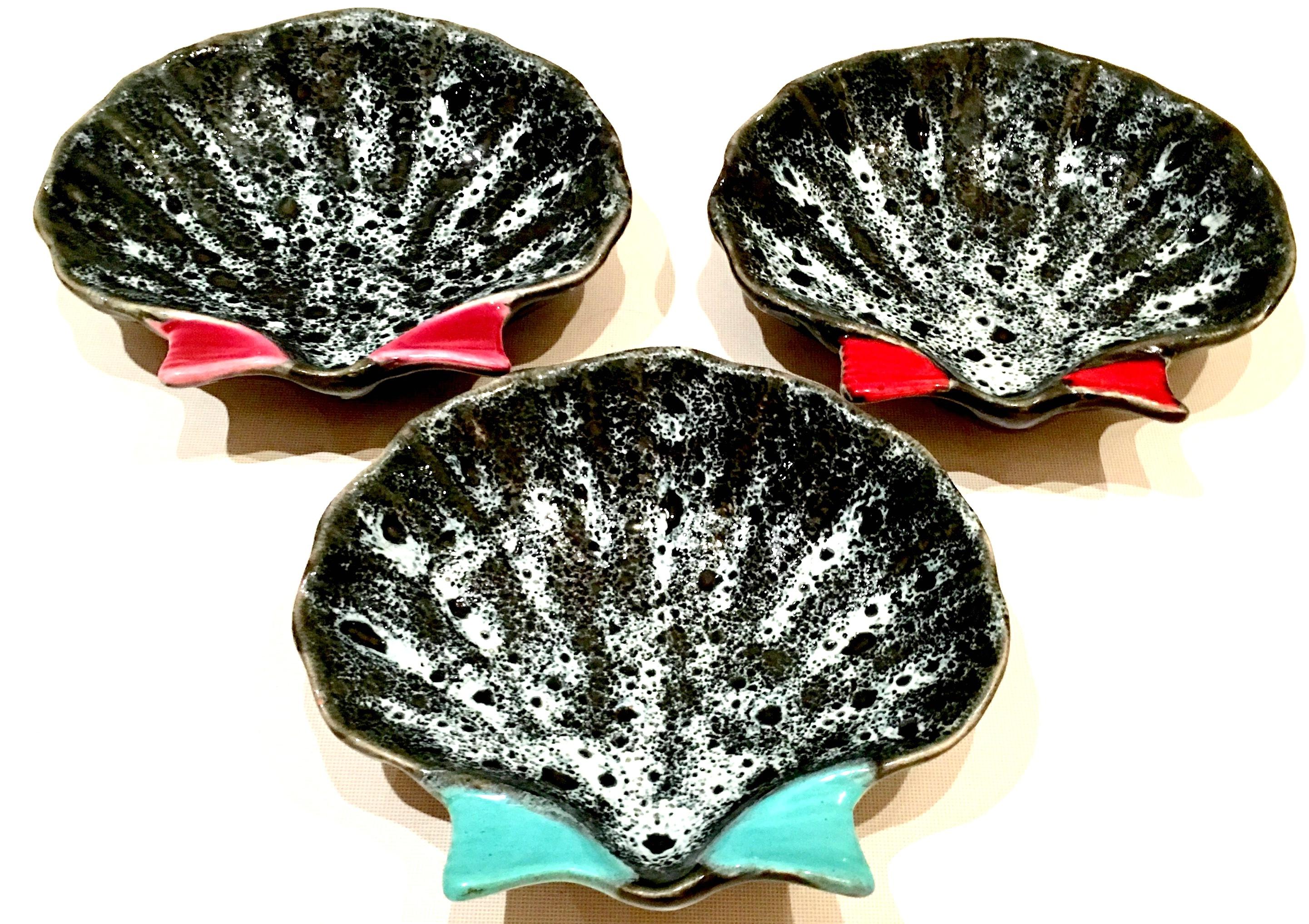 Mid-20th century French hand painted pottery oyster dish set of three pieces by, Luc Vallauris. Each dish has a different fin color, turquoise, pink and red. These south of France ceramic glaze and hand painted oyster dishes are each signed on the