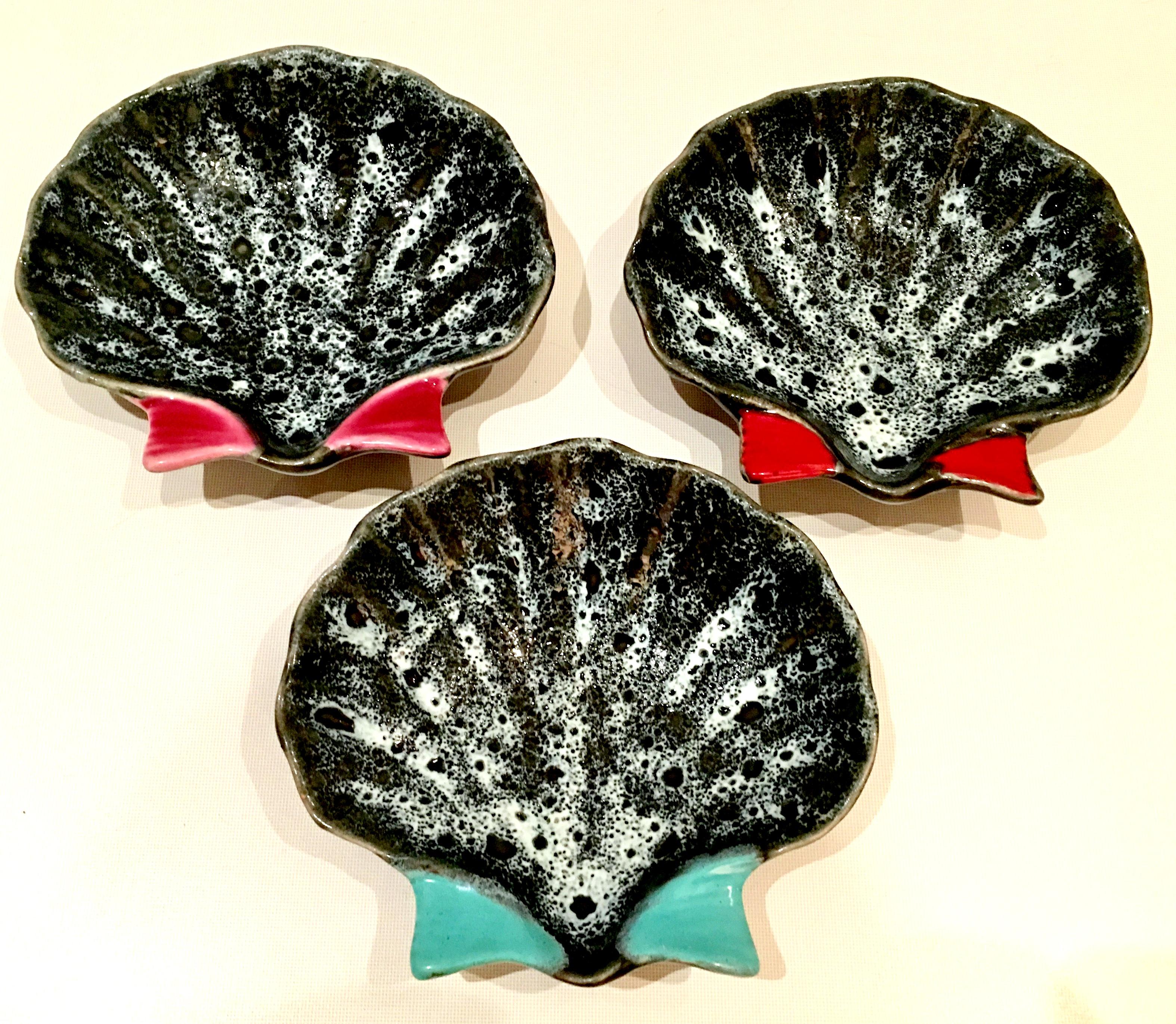 Mid-Century French Hand Painted Pottery Oyster Dish Set Of Three Pieces.  Each dish has a different fin color, turquoise, pink and red. These South Of France ceramic glaze and hand painted oyster dishes are each signed on the underside by, Luc