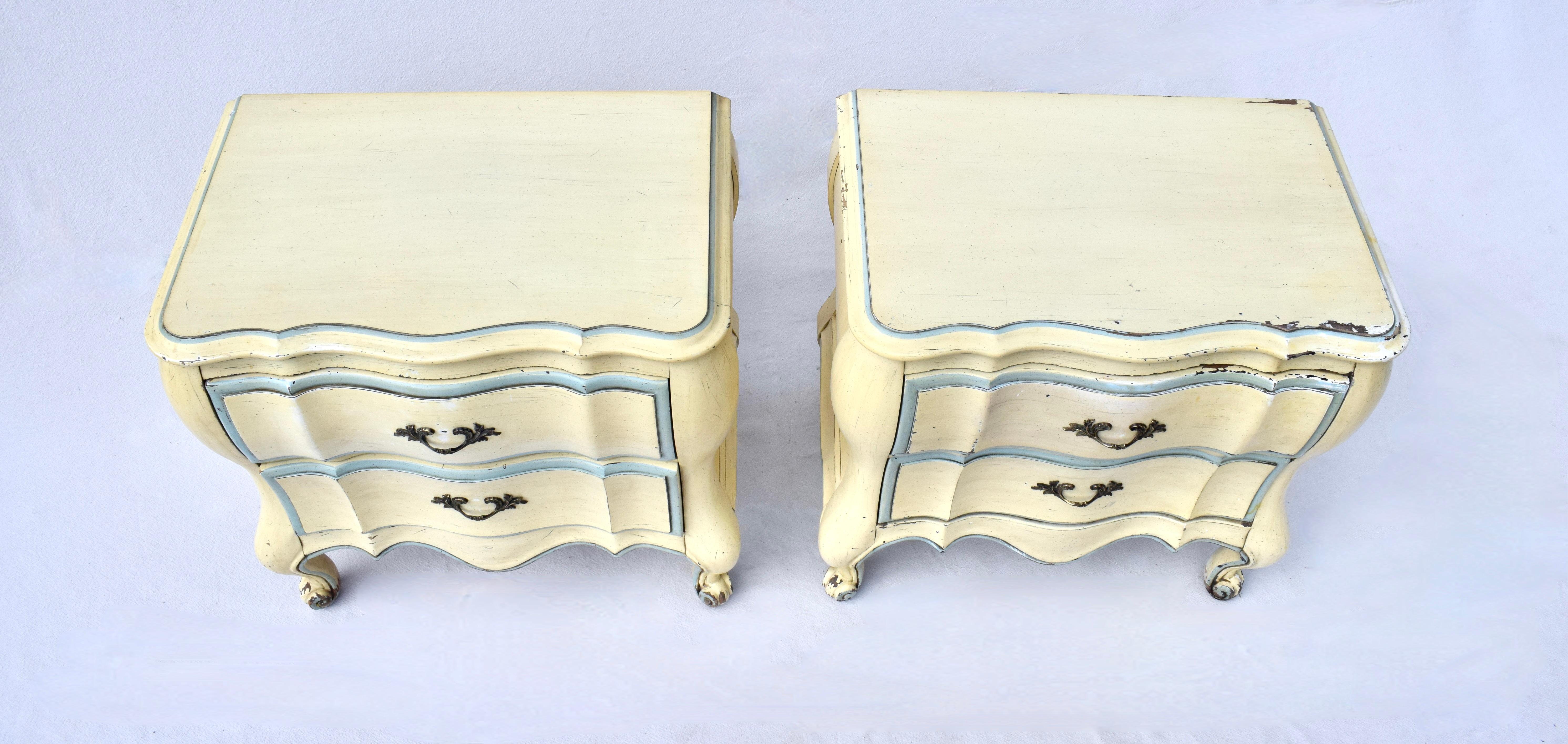 A sweet pair of vintage double drawer French  Bombe nightstands by White Fine Furniture, boasting much character & charm in the original butter yellow & Robin's egg blue original finish. Circa 1950's; fully hand detailed.