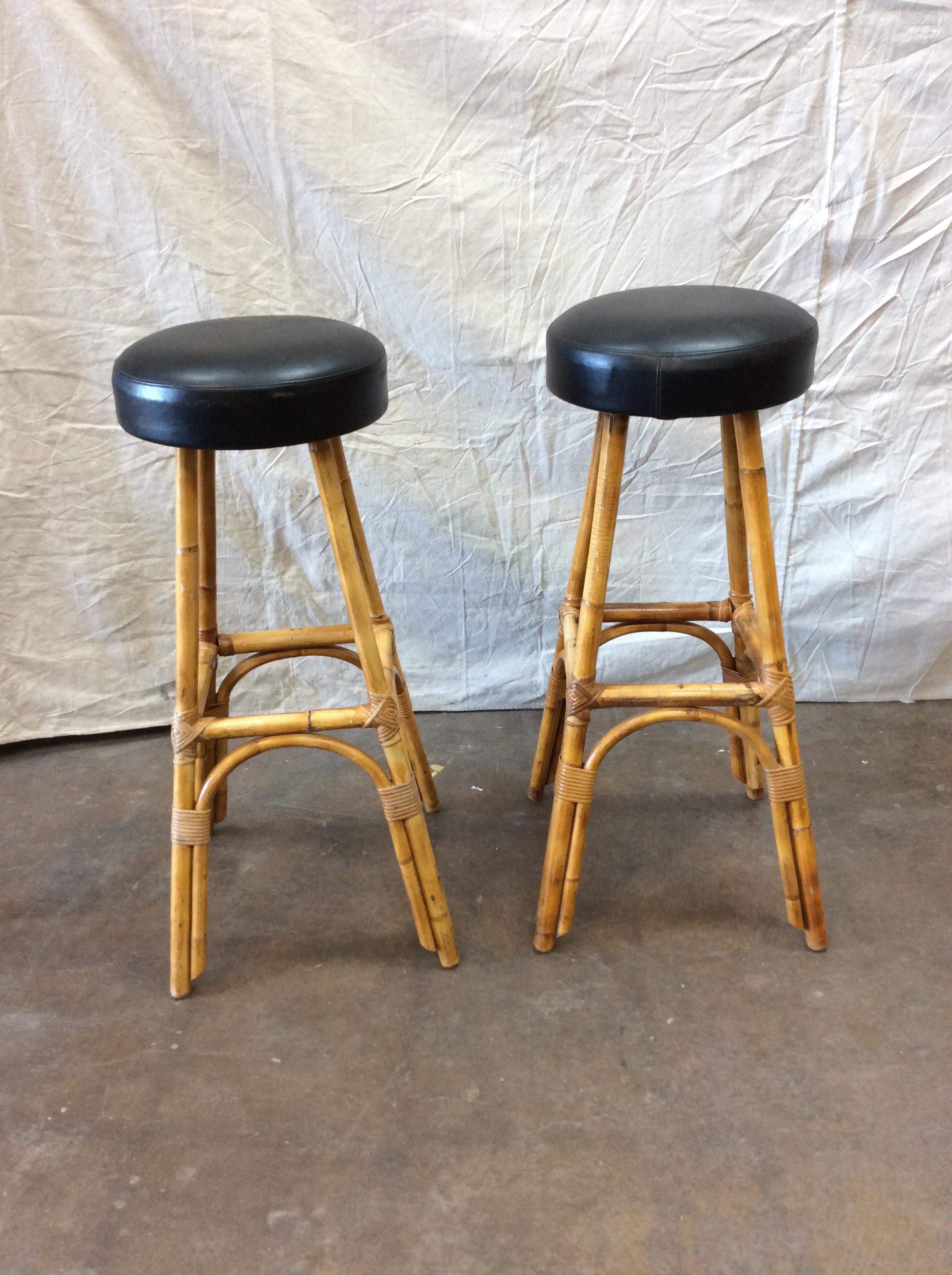 This pair of vintage bamboo barstools with black leather seats were made in France in the 1950s. With minor signs of wear on the seat, the stools are sturdy and ready for use. Bring a touch of the French Riviera to your home.

Each stool