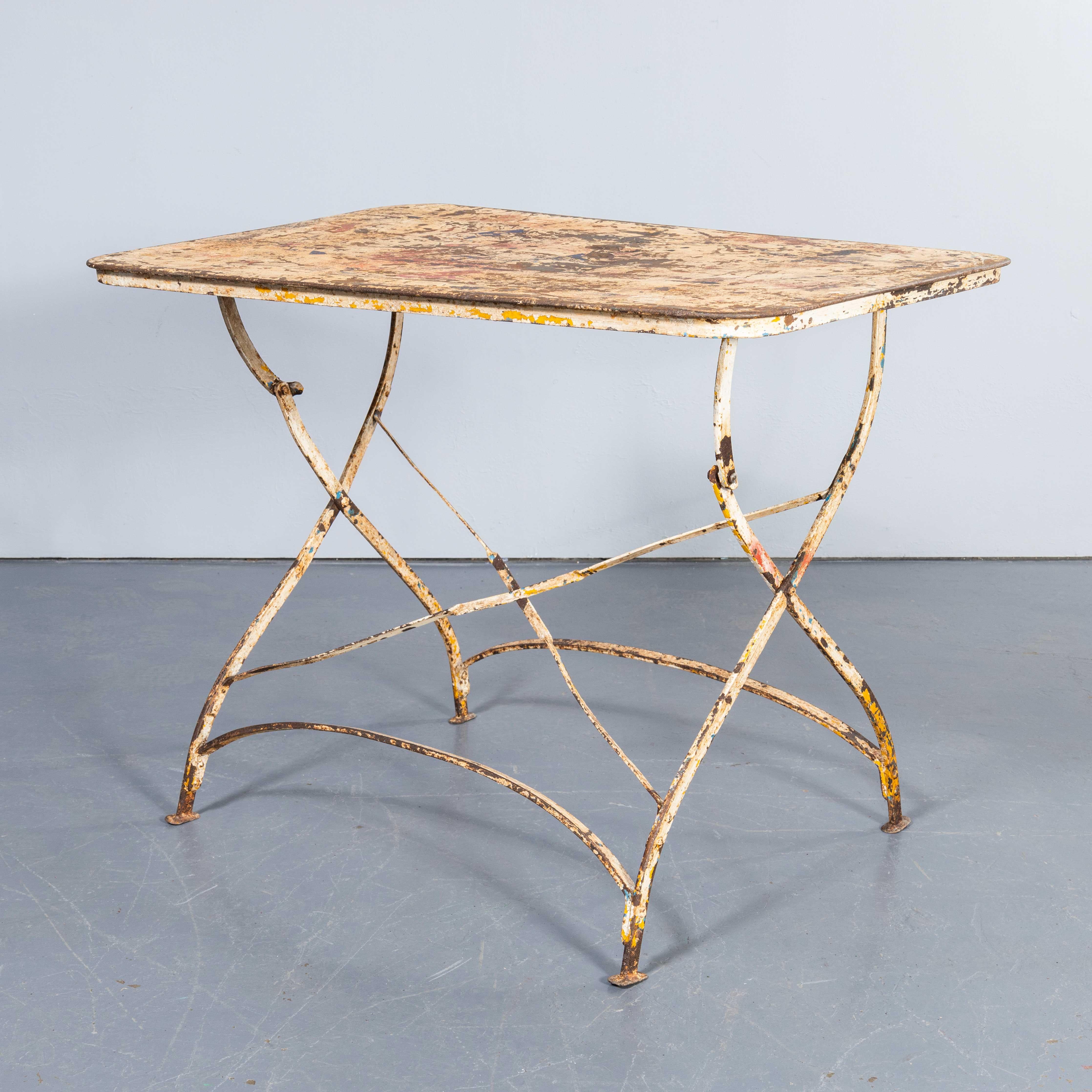 1950's French Rectangular Forged Metal Folding Dining Table. 
Good honest French metal dining table with a hand forged classic folding base and the original sheet metal top. The base has a graceful cross stretcher and curved frame. We love the