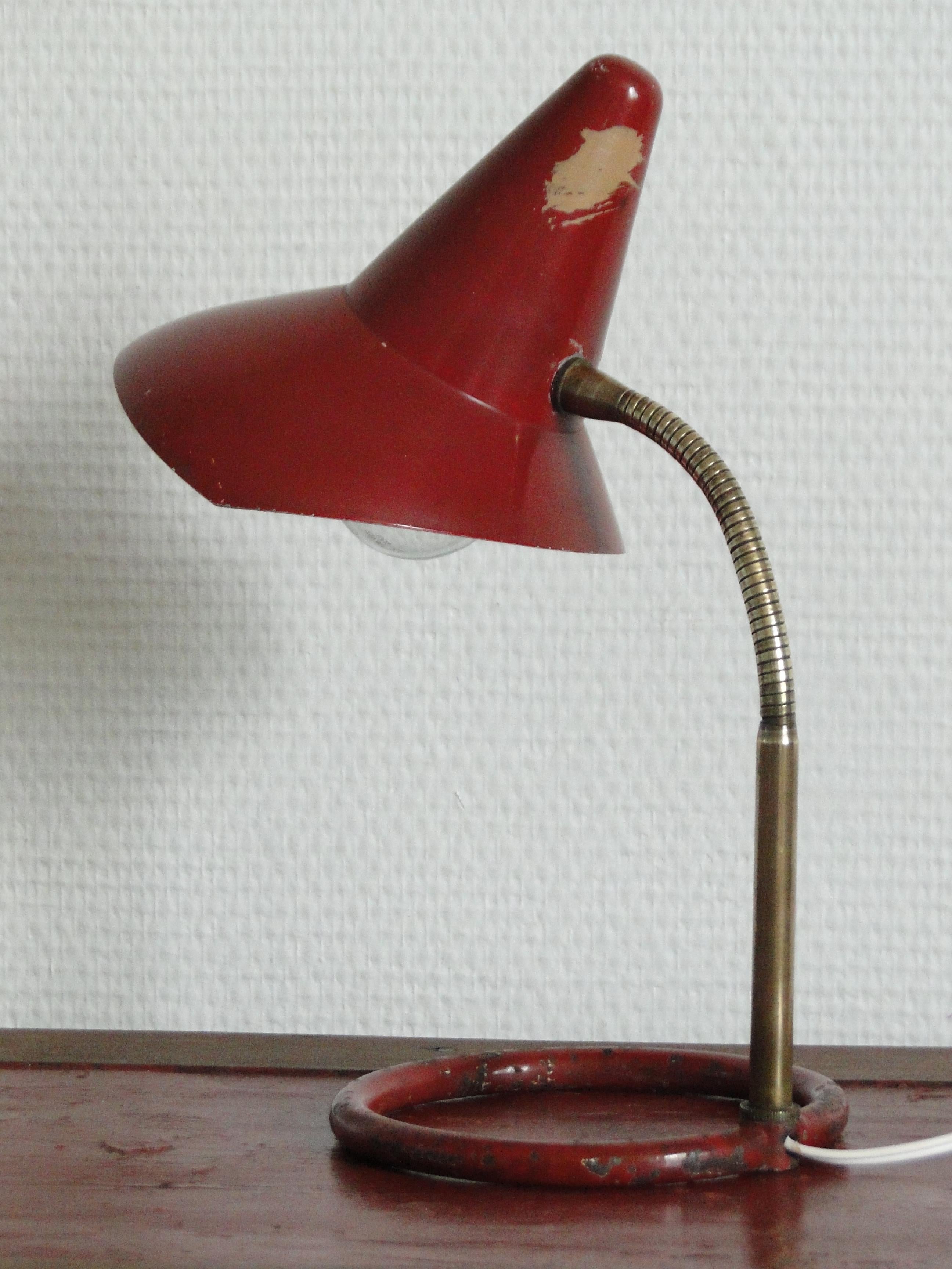 1950s table lamp attributed to Jacques Biny. An exceptionally clean and simple design executed in patinated brass with white painted inner shade. Quintessentially midcentury French in its conception and execution attributed to the incomparable