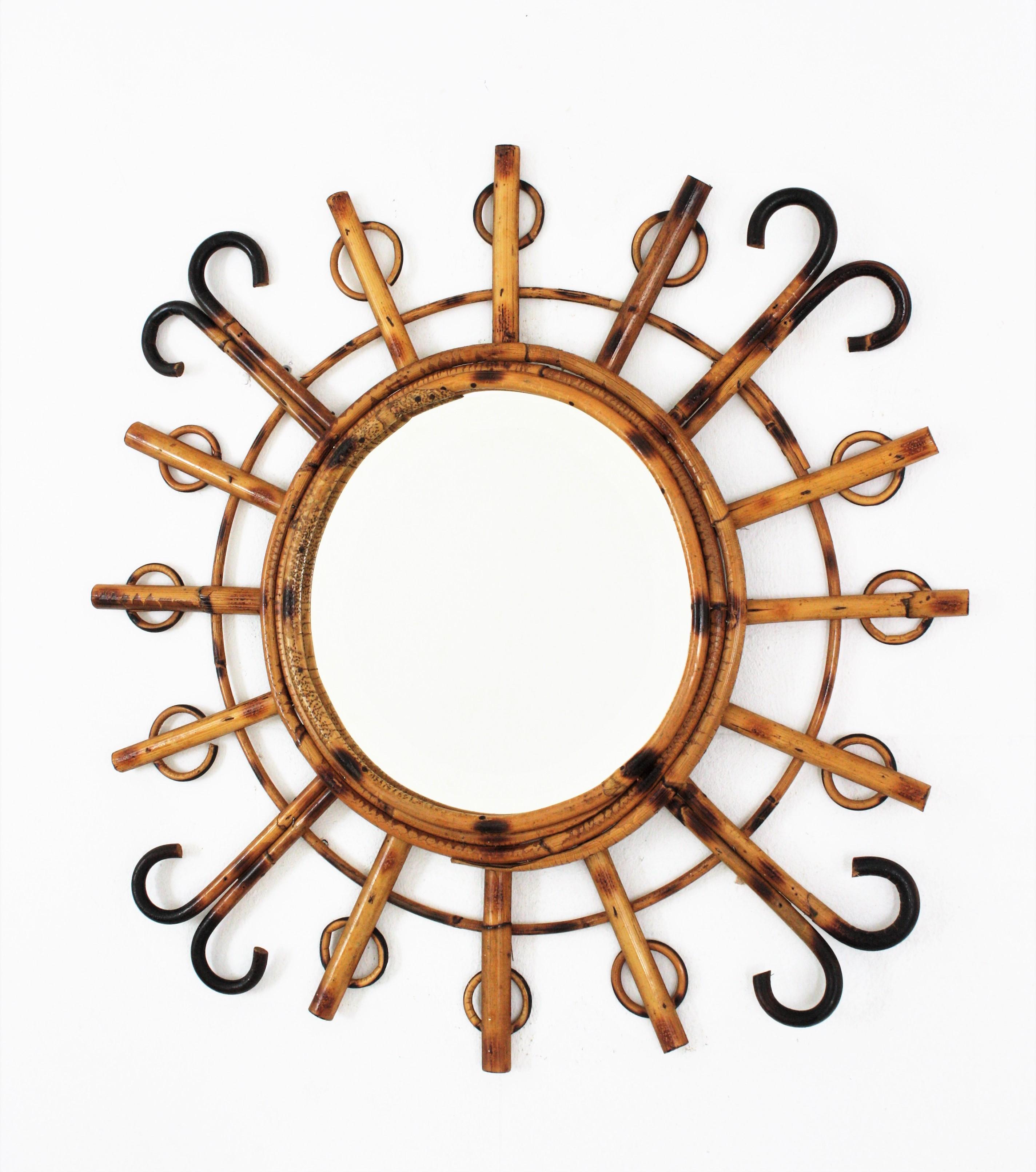 Sunburst starburst mirror handcrafted in rattan, France, 1950-1960.
A cool Mid-Century Modern handcrafted rattan mirror with star or sunburst shape and all the taste of the Mediterranean French Riviera style. It has curved endings and semi-circle
