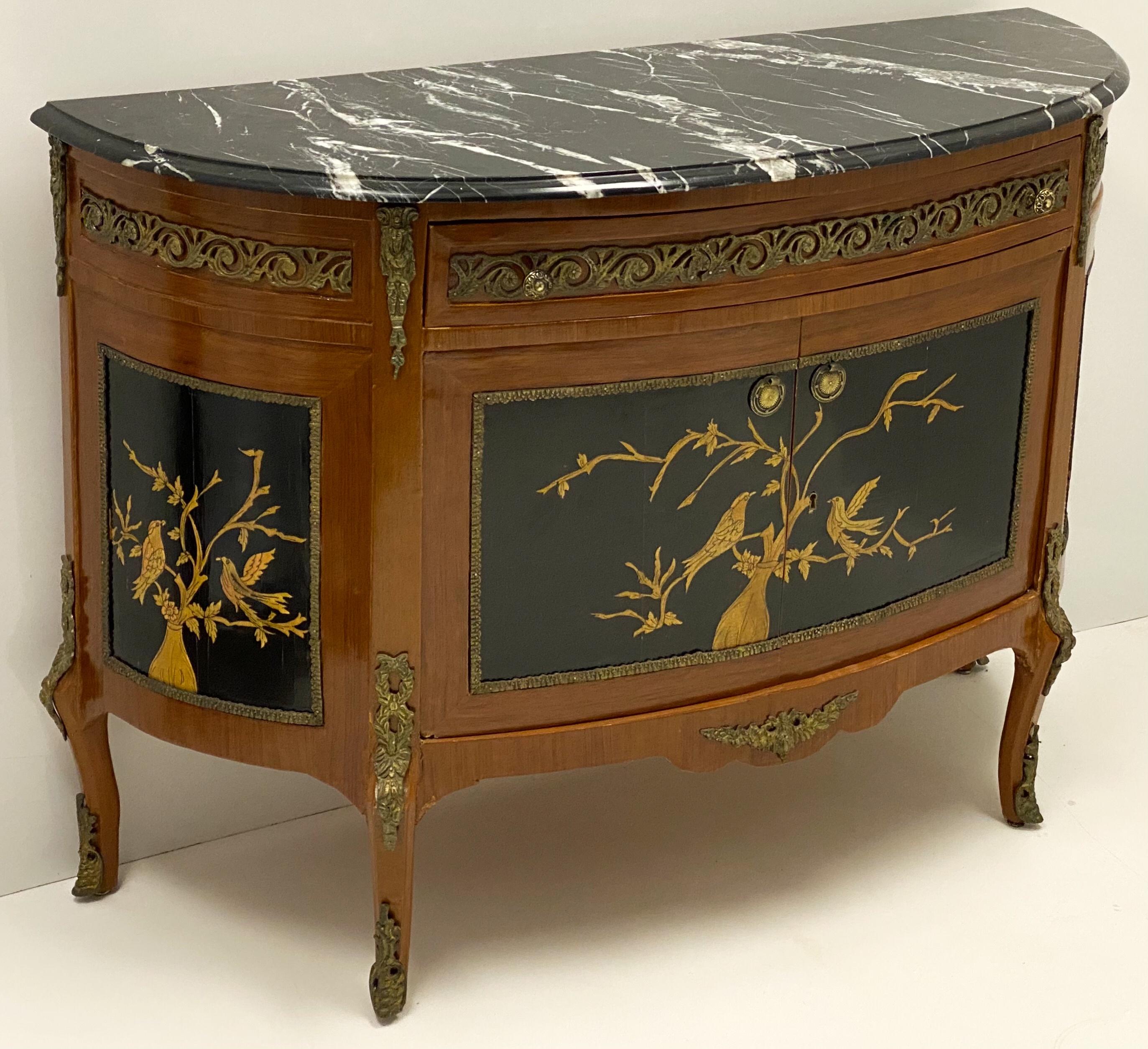 This is a 1950s chinoiserie demilune cabinet with marble top and bronze surmounts. The gilt birds are on an ebonized panel. It opens to open space. It would work well from foyer to bathroom. The piece is most likely Italian. It is unmarked and in