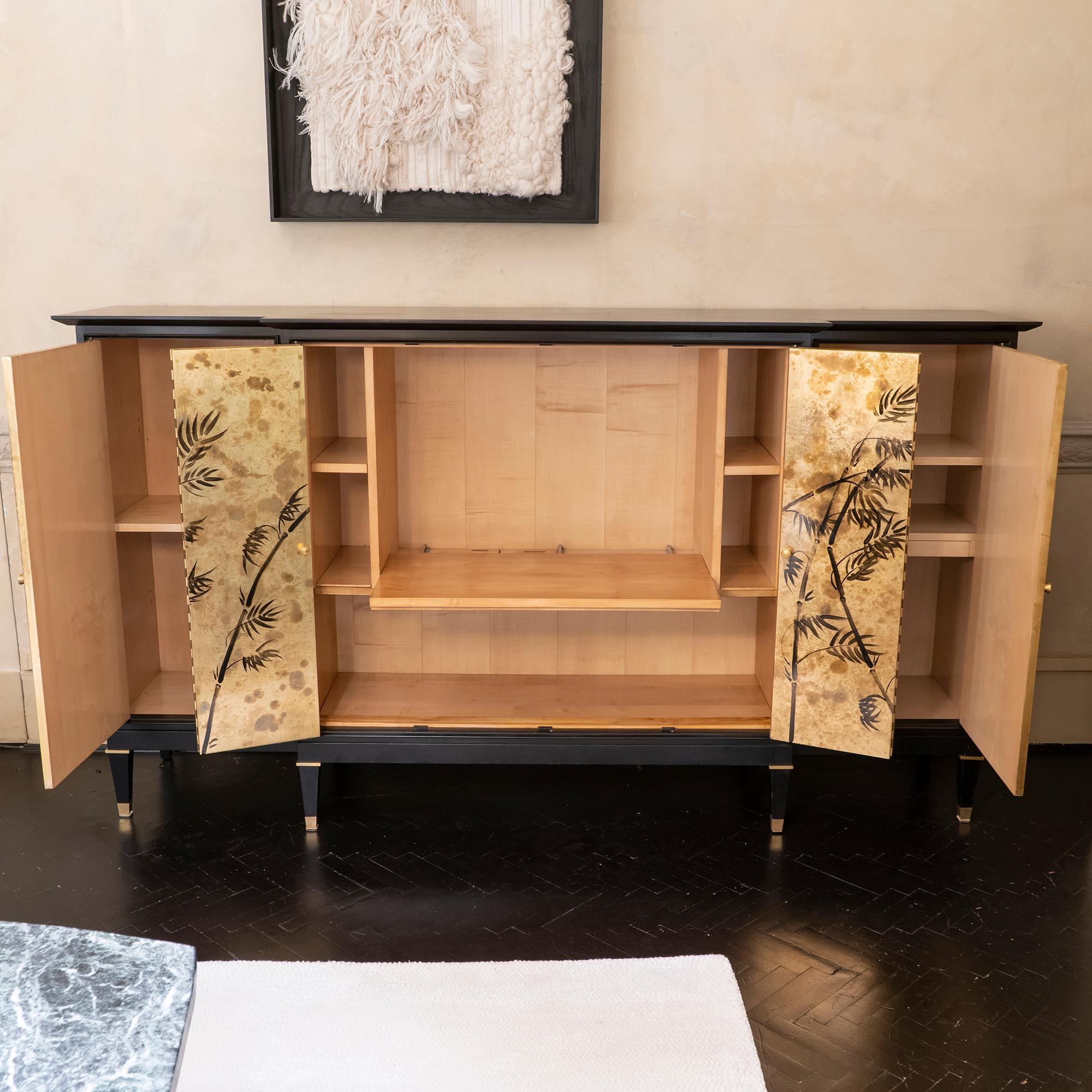 1950s French black cabinet with natural oak wood interior, created as a TV set container, the bottom shelf is in fact sliding, and the two central doors open dividing to the side, one side section with two shelves one with pull out shelf, the other