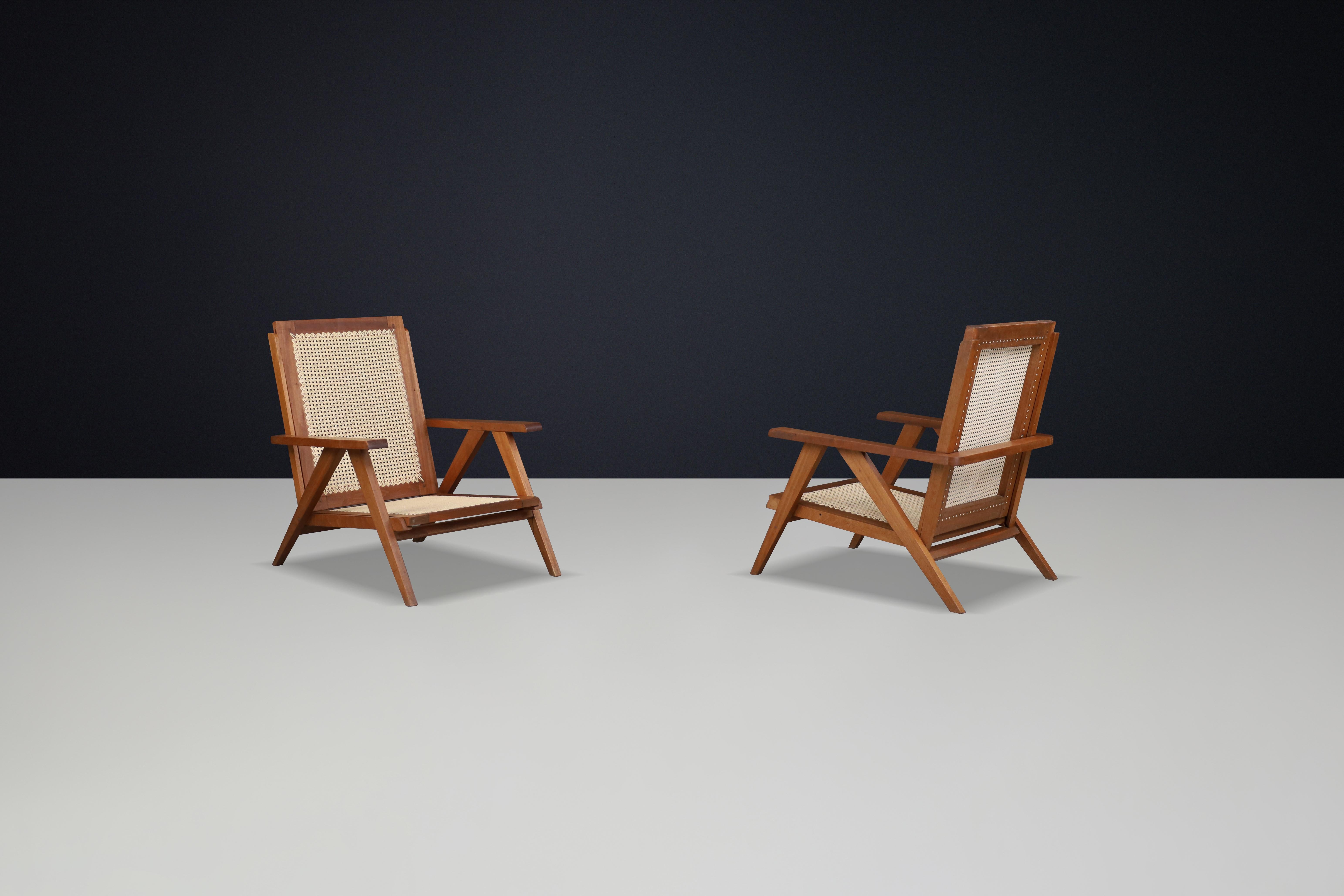 Canne Fauteuils en teck et cannage français des années 1950 - Mid-Century Modern Icons en vente