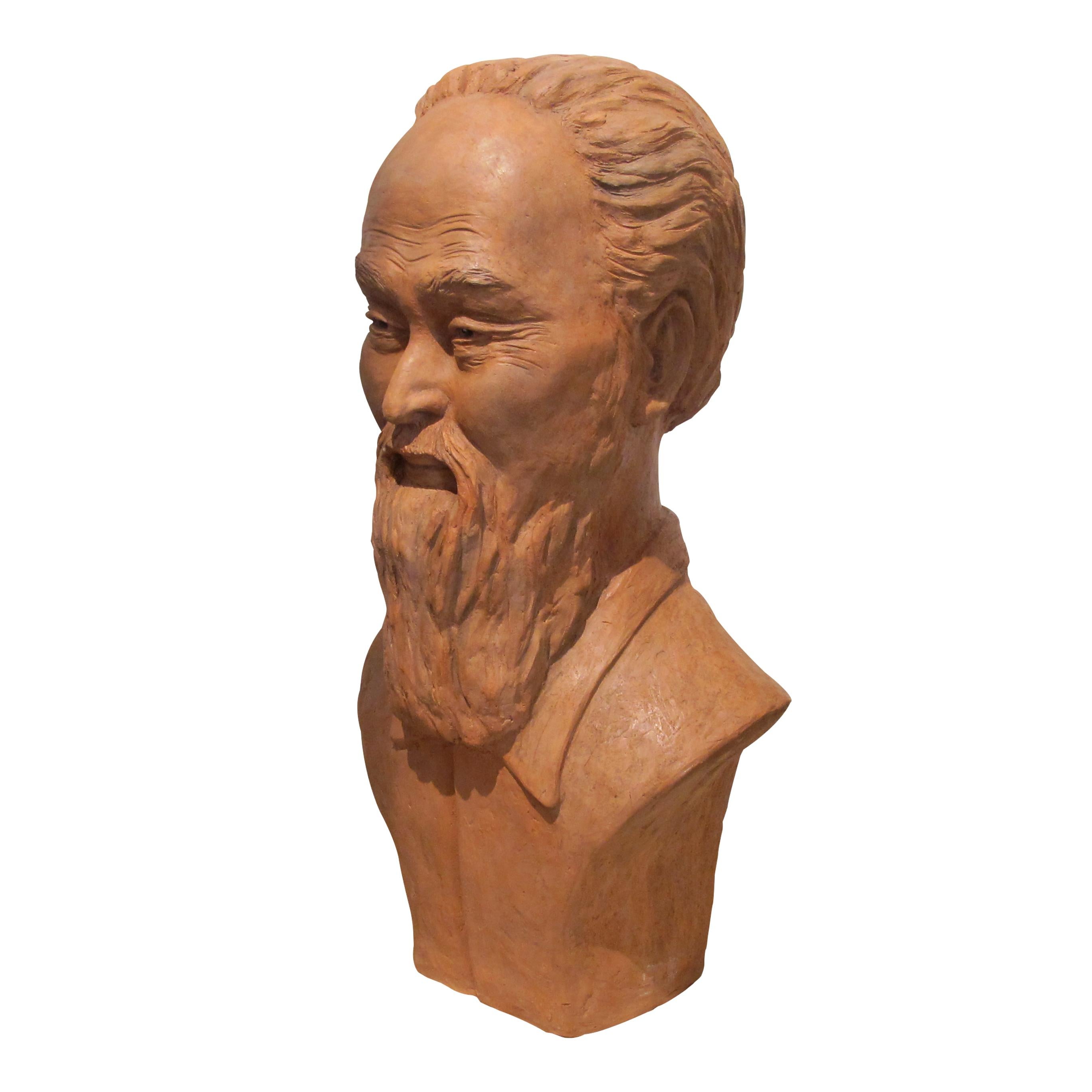 This is a stunning hollowed terracotta bust sculpture representing a Chinese man, French 1950s. The artist really captured the expression of the gentlemen in great details, from which ever angles you look at the bust, the light plays with the