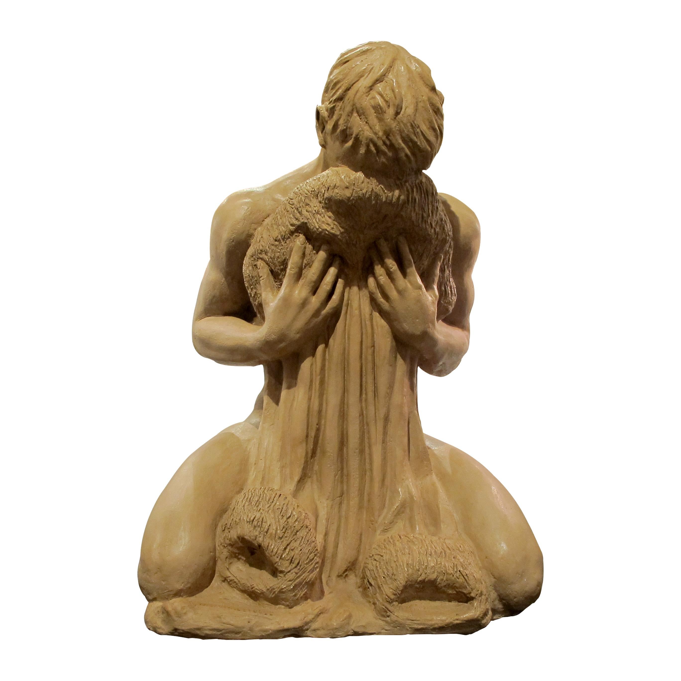 Very elegant hollowed terracotta sculpture of a nude young man kneeling, 1950s French. The artist achieved a smooth terracotta finish for the young man by contrast with the textures on the cloth the young man is holding. It is a beautiful capture of