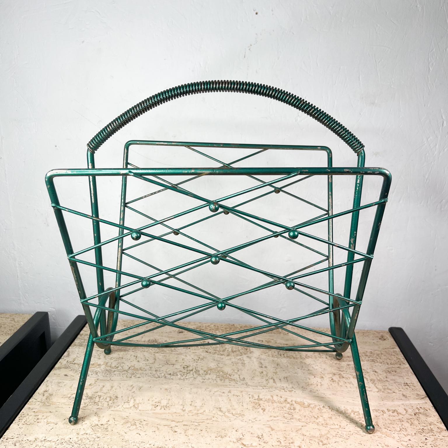1950s French Vintage Magazine record rack in green metallic 
18 h x 14.75 w x 13.25 d
No markings present. 
Vintage unrestored condition with nicks on the original finish. 
Refer to images.

