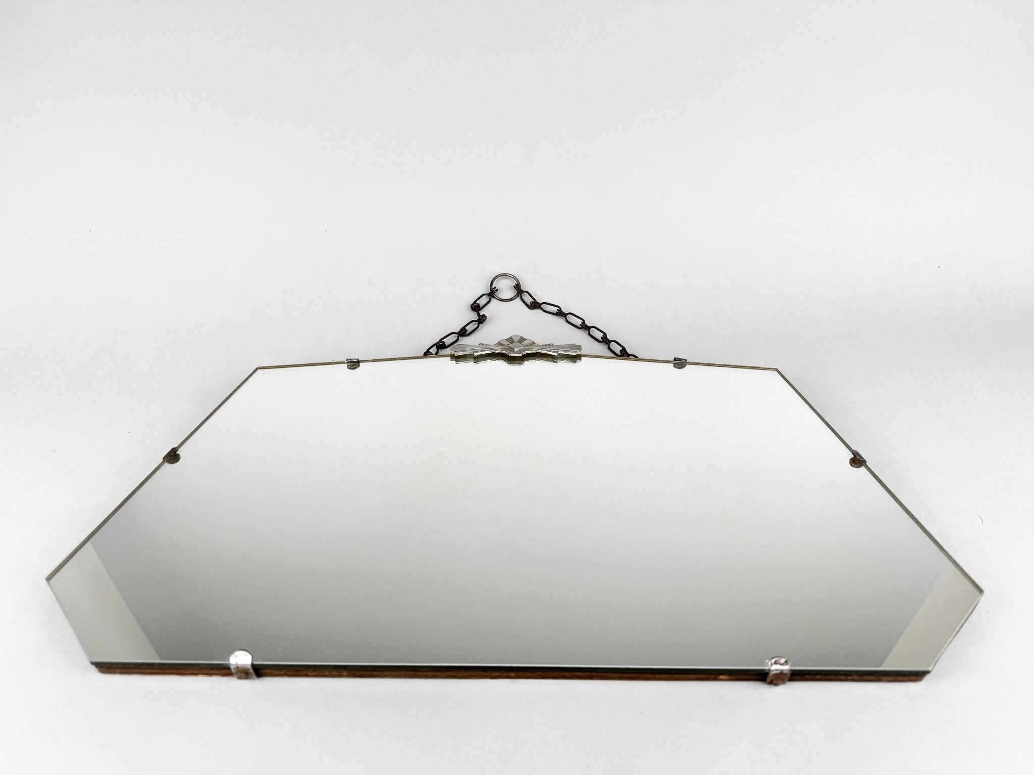 Espejo de pared vintage con herrajes cromados y cadena metálica para colgar.