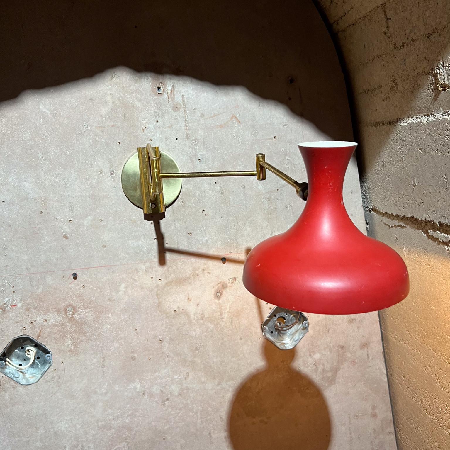 AMBIANIC presents
1950s French Wall Sconce Red Lamp Patinated Brass France
Attributed to Pierre Guariche. Made in France.
Unmarked
6 h x 7 w x 25.5 long
Articulating arm
In vintage condition
New wire retrofitted new socket new backplate. 
Original