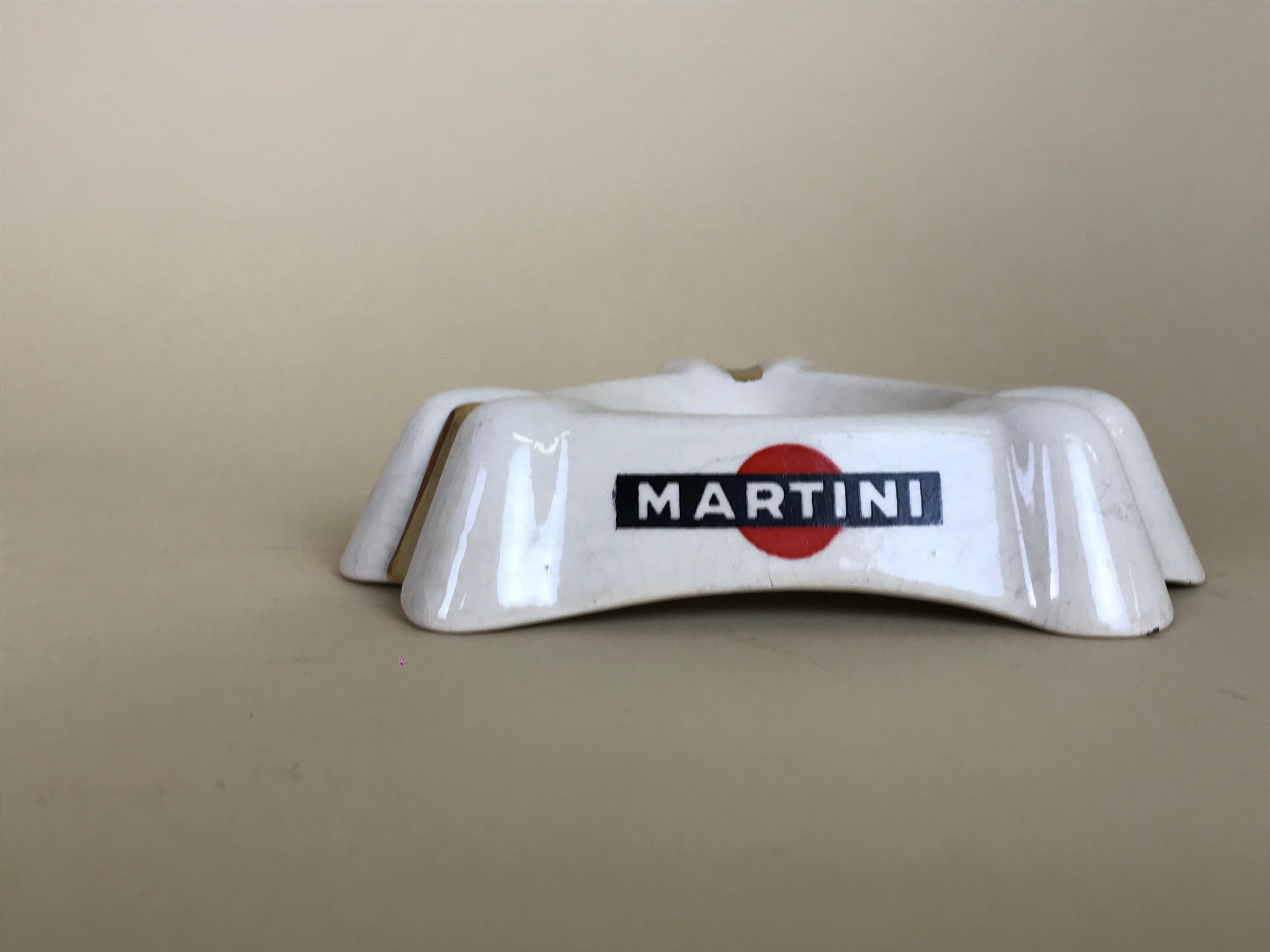 1950s French white triangular ashtray with gold details and Martini logo on all three sides, in earthenware by Luneville Faience, France.

Marked on bottom Luneville KG Made in France 63.

Collector's note:

Martini is a brand of Italian