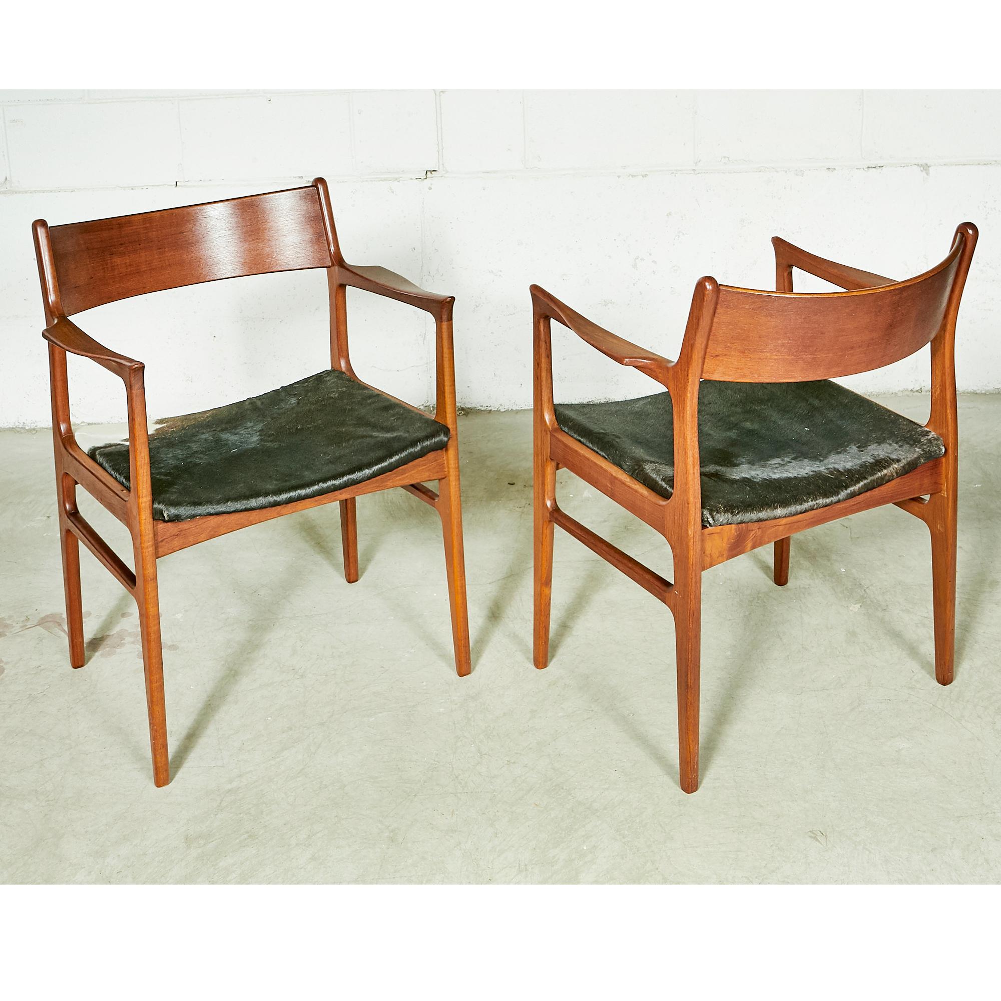 Vintage pair of 1950s Funder-Schmidt Madsen Odense Denmark sculpted teak arm chairs with new cowhide seats. In newly refinished condition. Marked underneath. 