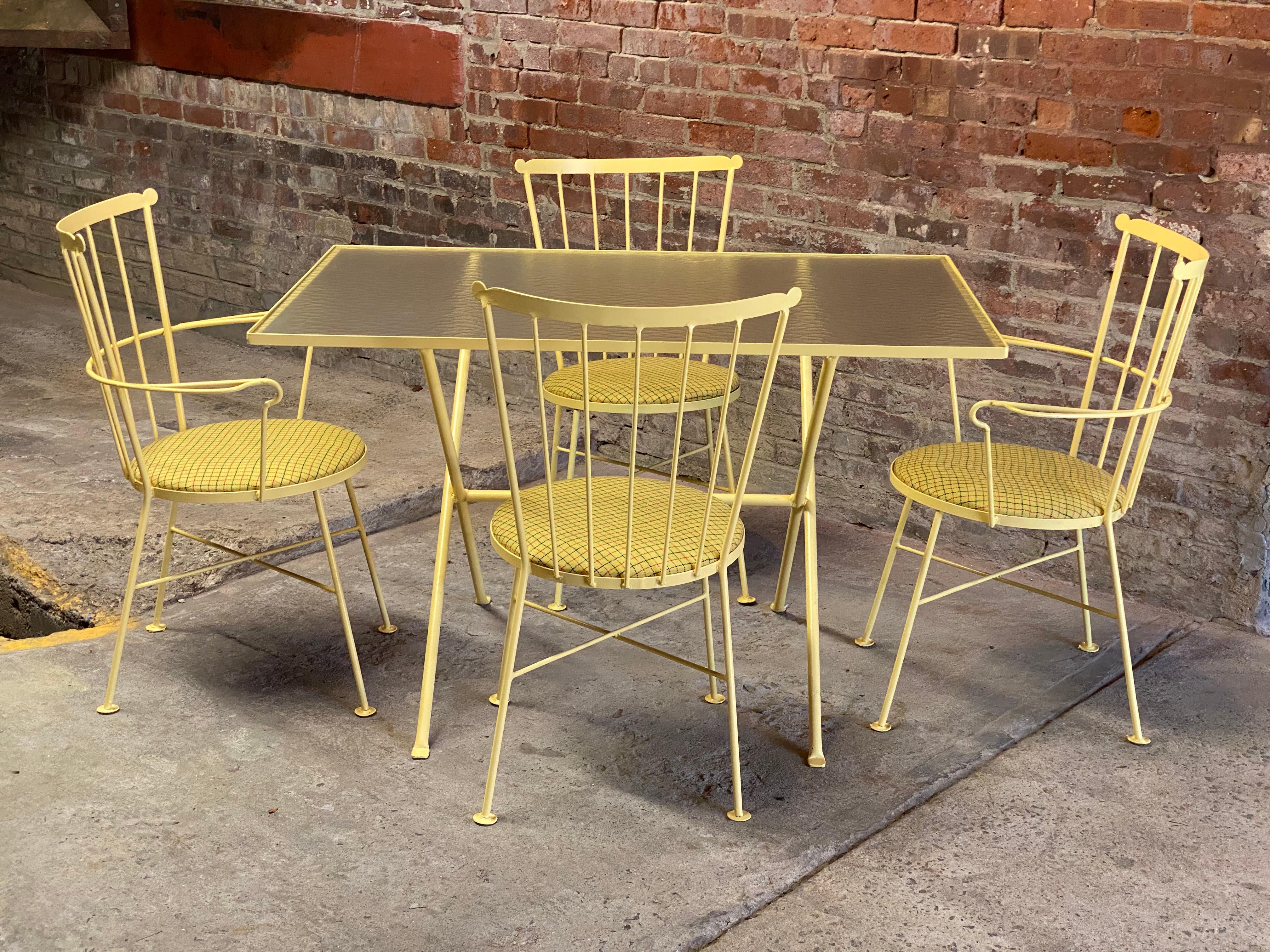 A fresh classic modernist take on the Windsor chair and a trestle base dining table. This set from Gallo Original Iron Works features two arm chairs and two side chairs with a trestle base table with the original textured wavy glass top. Circa