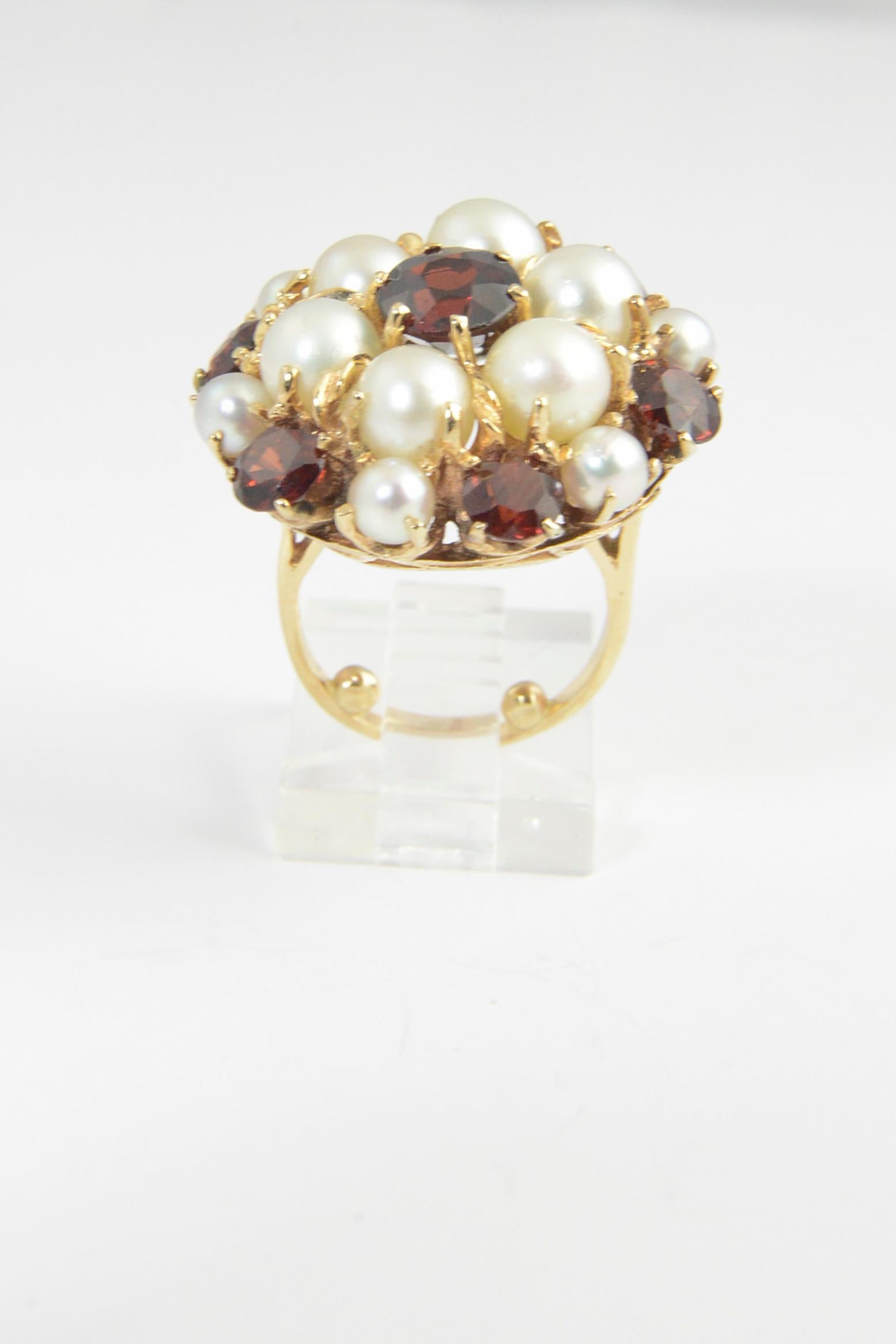 1950s Dome cocktail ring featuring a cluster of garnets and cultured pearls set in 14K yellow gold mount.
 US size 3.5 - it can easily be size up either by removing the beads or adding to the back. 
No maker's mark.