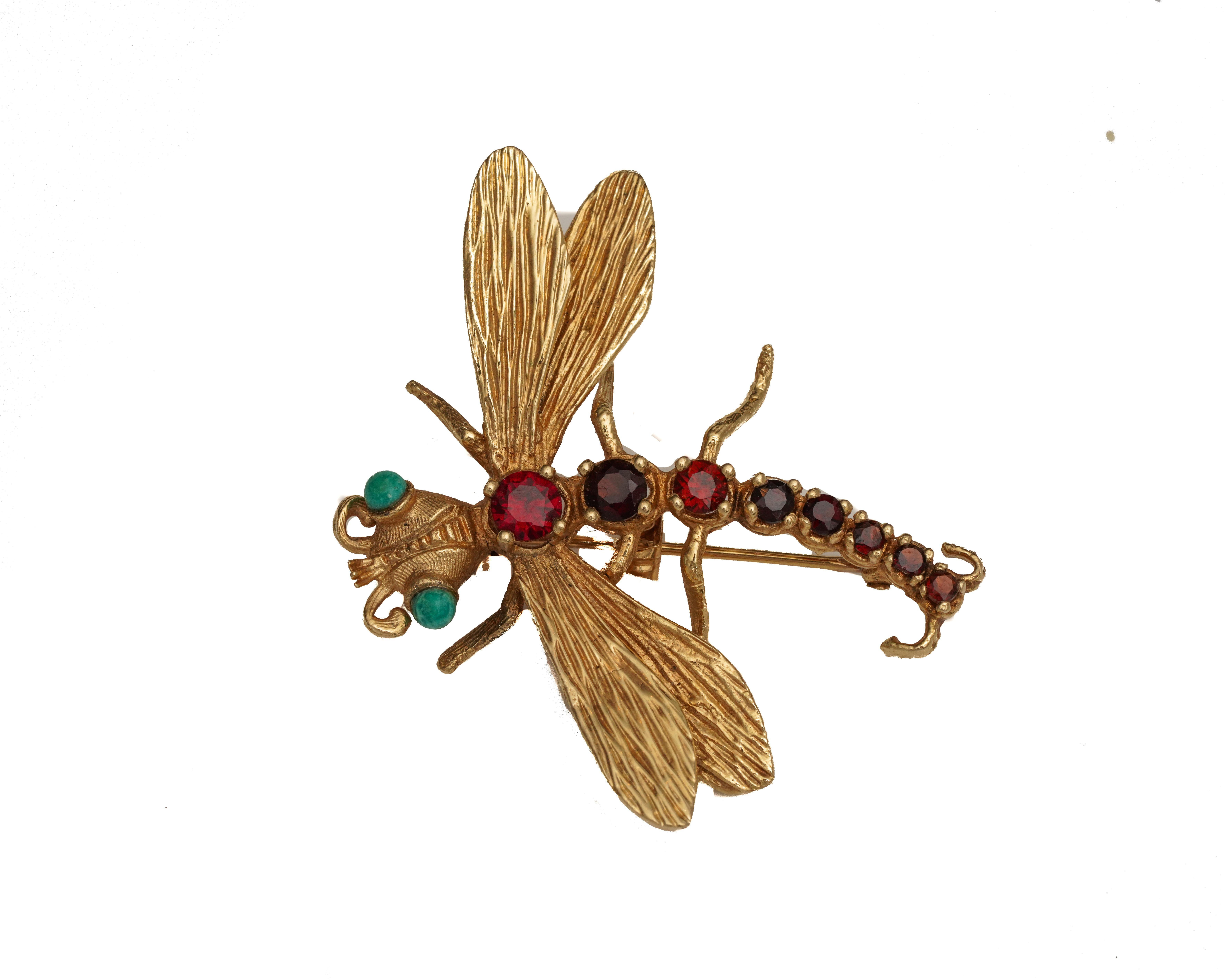 Item Details:
Metal type: 14 Karat Yellow Gold
Weight: 7.2 grams 
Measures: 2 inch length x 2 inch width

Features: 
Tail - made of 8 Garnet Stones graduating down in size, all round stones
Eyes: 2 Turquoise stones
Wings: Hand etched textured high