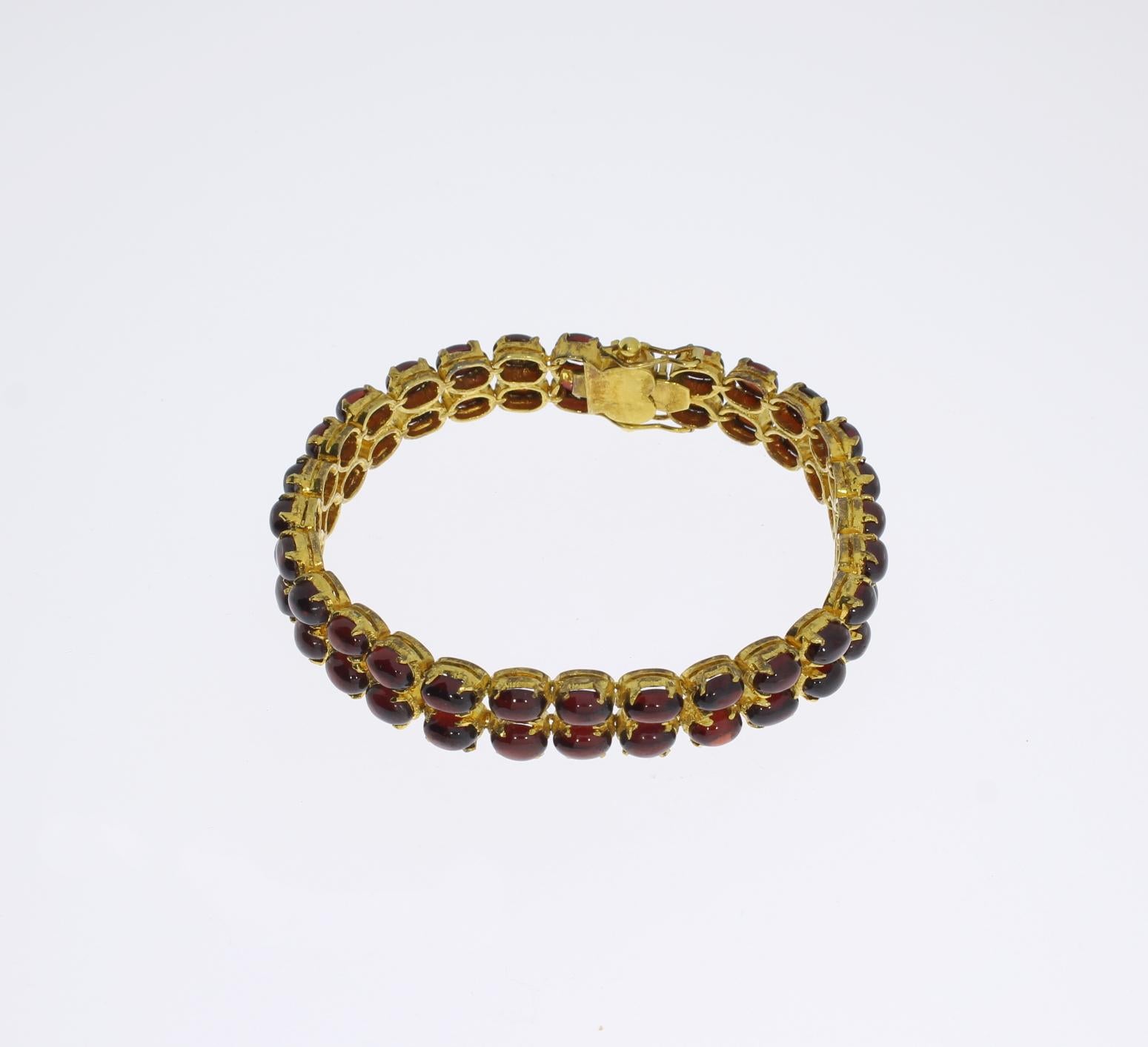 Designed 1950's with two rows 56 cabochon-garnets. Mounted in silver, gold-plated. Weight: 27,24 grams. 
Length: 7.28 in ( 18,5 cm ), Width: 3.54 in ( 9 cm )