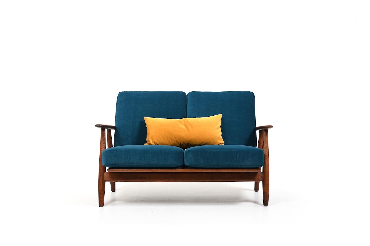 GE-240/ two seater sofa by Hans J. Wegner for Getama Denmark 1950s. Made in solid oak. Wonderful old patina and very good condition. In consideration of their age, the old feathers in the cushions were restored and reupholstered with a petrol color