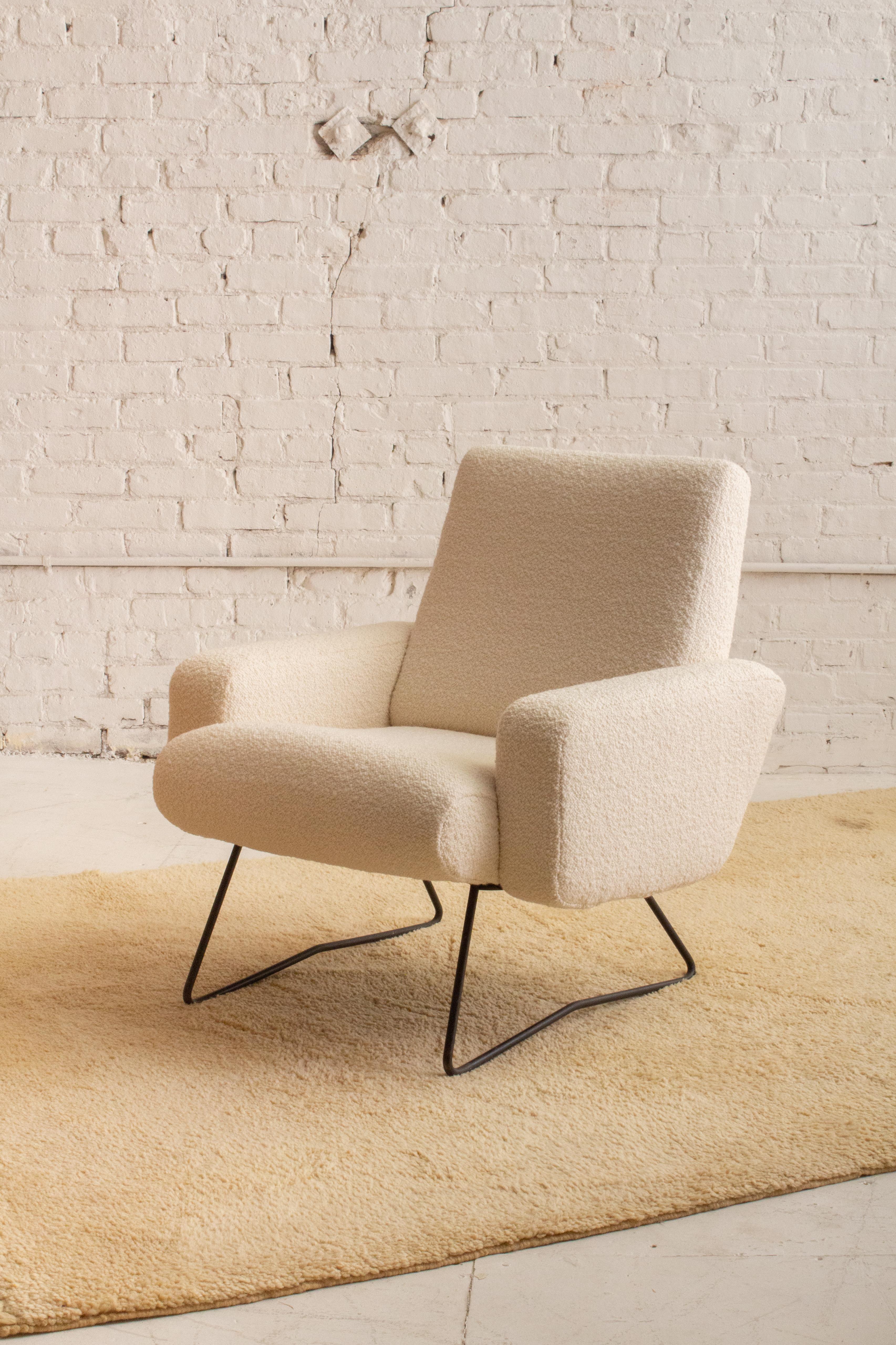 A mid century armchair attributed to Geneviève Dangles and Christian Defrance. Iron base and new wool bouclé upholstery. Sourced in Northern Italy. Two available, sold separately.

Geneviève Dangles and Christian Defrance, both born in 1929, were a