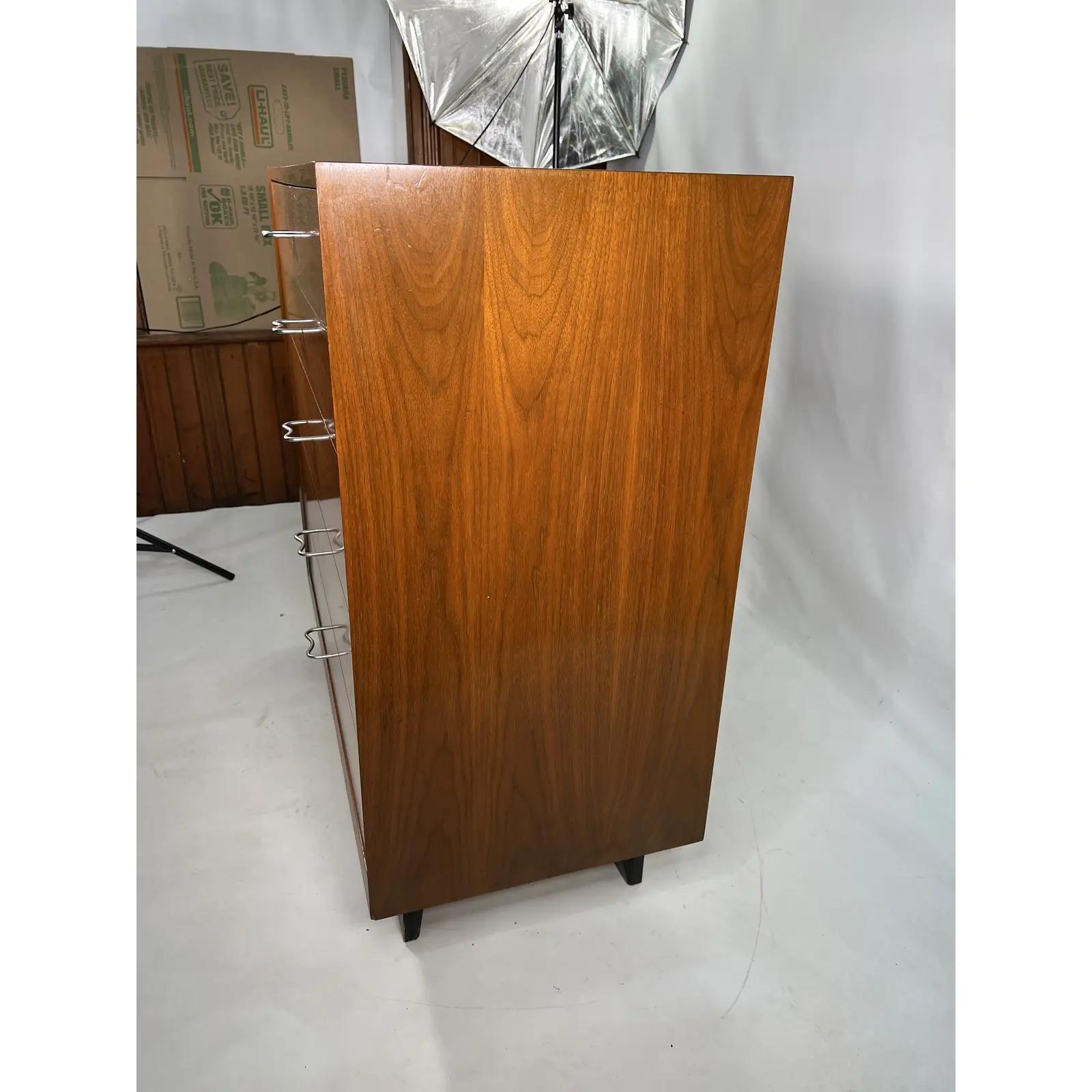 This beautiful George Nelson for Herman Miller Dresser was designed and manufactured in the 1950s. It is made out of walnut and has aluminum pulls.
