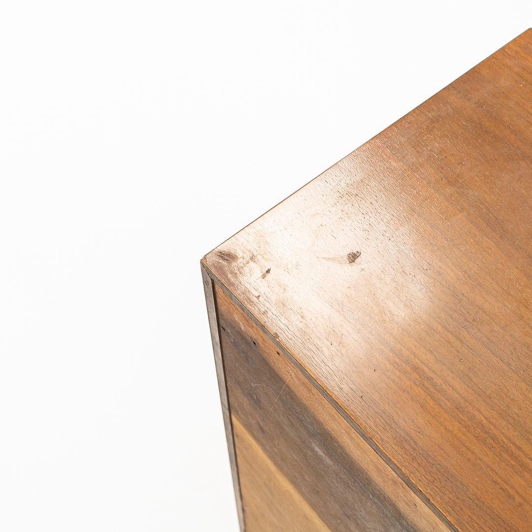 This is an uncommon Two-Door Walnut Cabinet, Model 4632, designed by George Nelson for Herman Miller in 1946. This design was part of George Nelson's Basic Cabinet Series. The listed price includes the cabinet itself, excluding the Nelson bench as