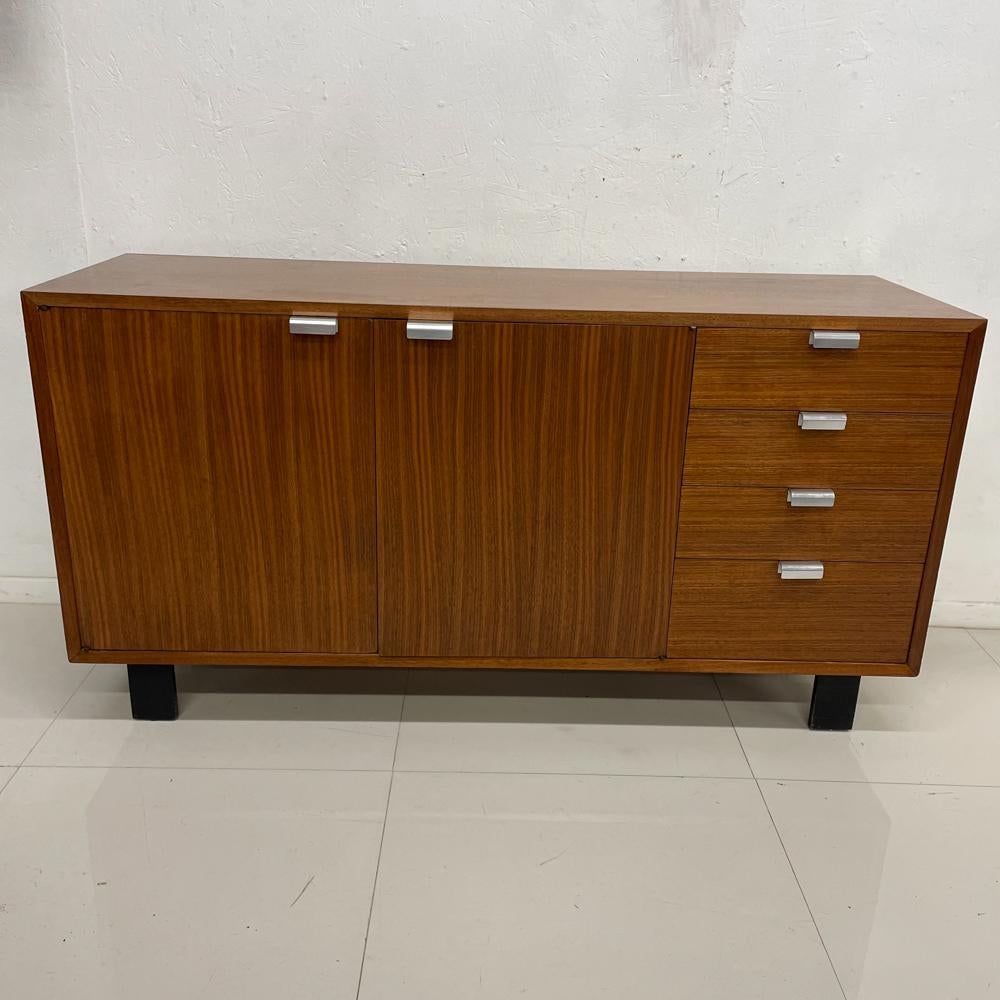 1950s MCM Iconic Furniture Piece Walnut Cabinet Dresser classic sculptural aluminum pulls. (Very unusual to find these oversized pulls).
Designed by George Nelson for Herman Miller.
Mounted on sculptural wood legs painted black.
All drawers are