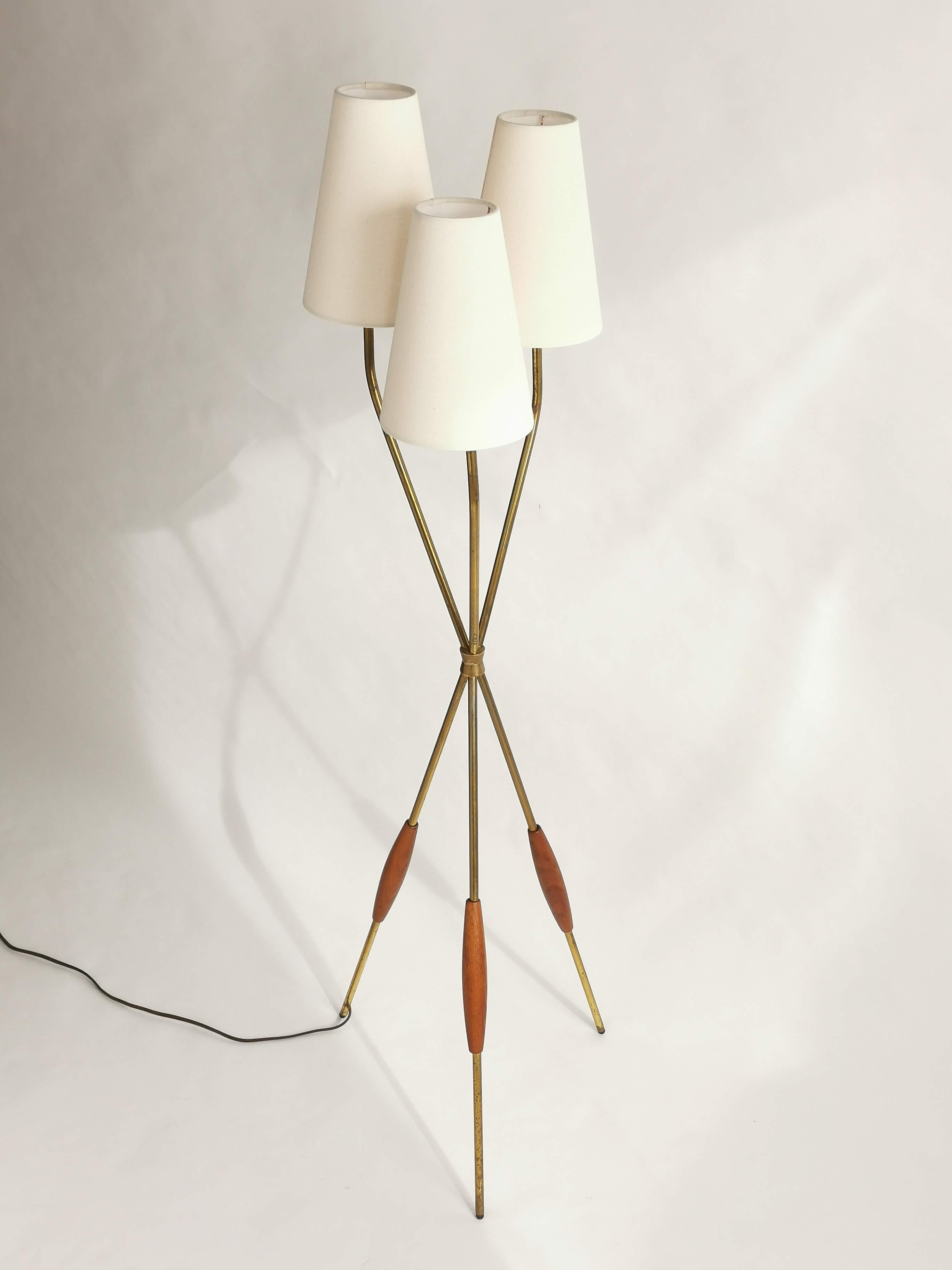 Iconic tripod floor lamp from Gerald Thurston for Lightolier.

Three new shade in an off-white tone supplied with order. 

Each shade measure 10 in. high, 7 in. wide on base and 4 in. wide on top. 

Contain three regular E26 size socket rated