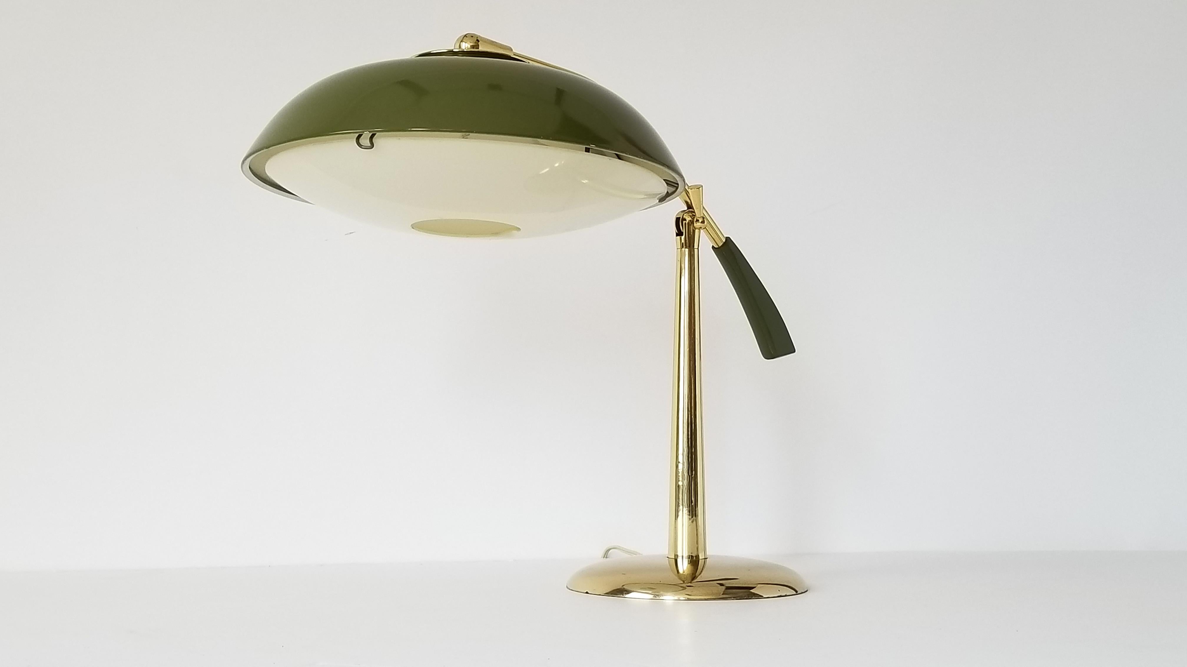 Brass table lamp with an olive green enameled shade and counterweight. 

Acrylic diffuser under.

Shade measure 13 inches diameter. 

On/Off rotating switch on shade.

Regular E26 size socket.