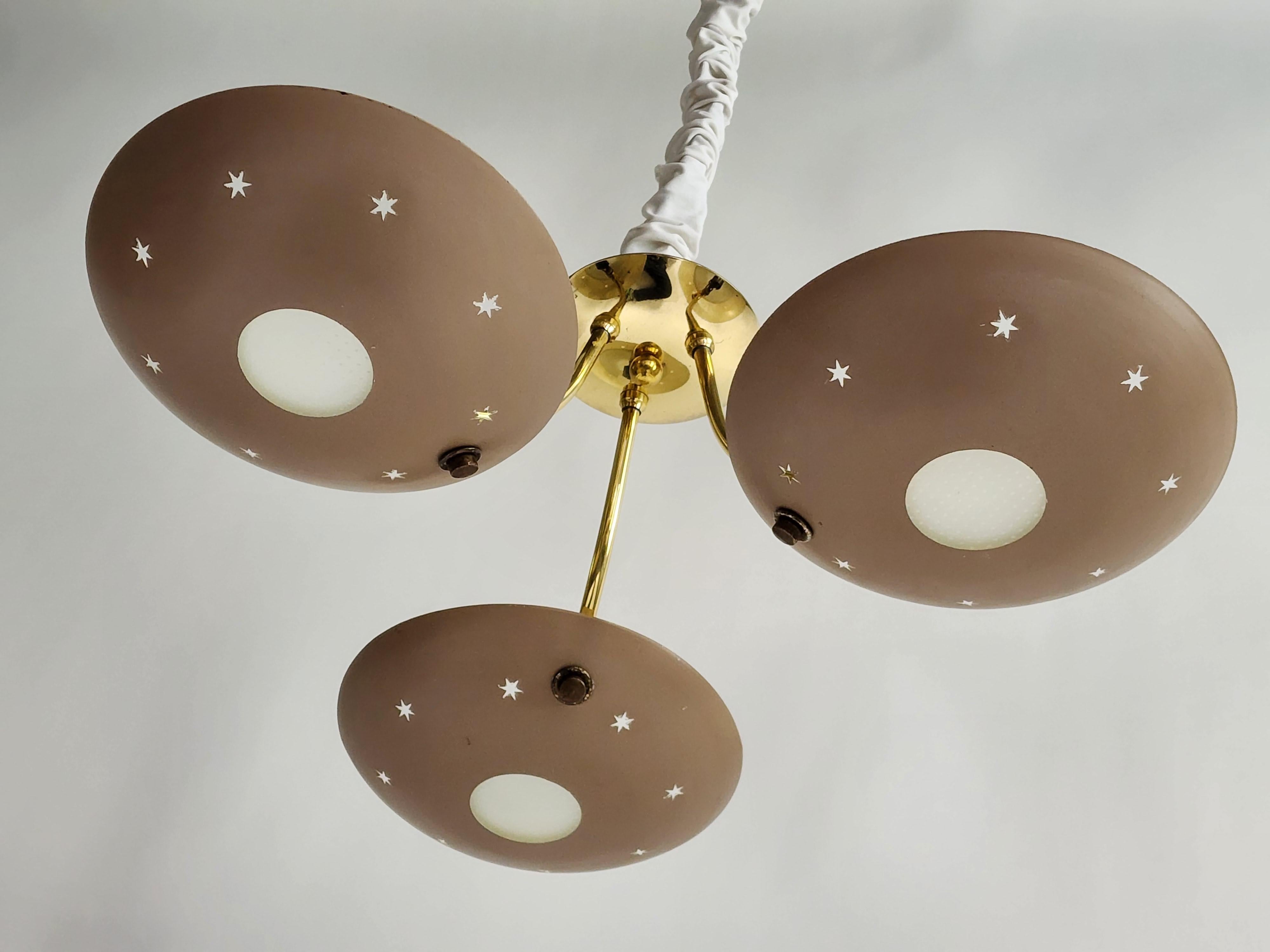 Enameled aluminium  shade with a  pierced star motif  on a brass structure .

Well made strudy construction . 

Each shade measure 9.5 in wide by 2 in high . Glass diffuser under .

3 Bakelite socket rated at 40 watt each 

 

