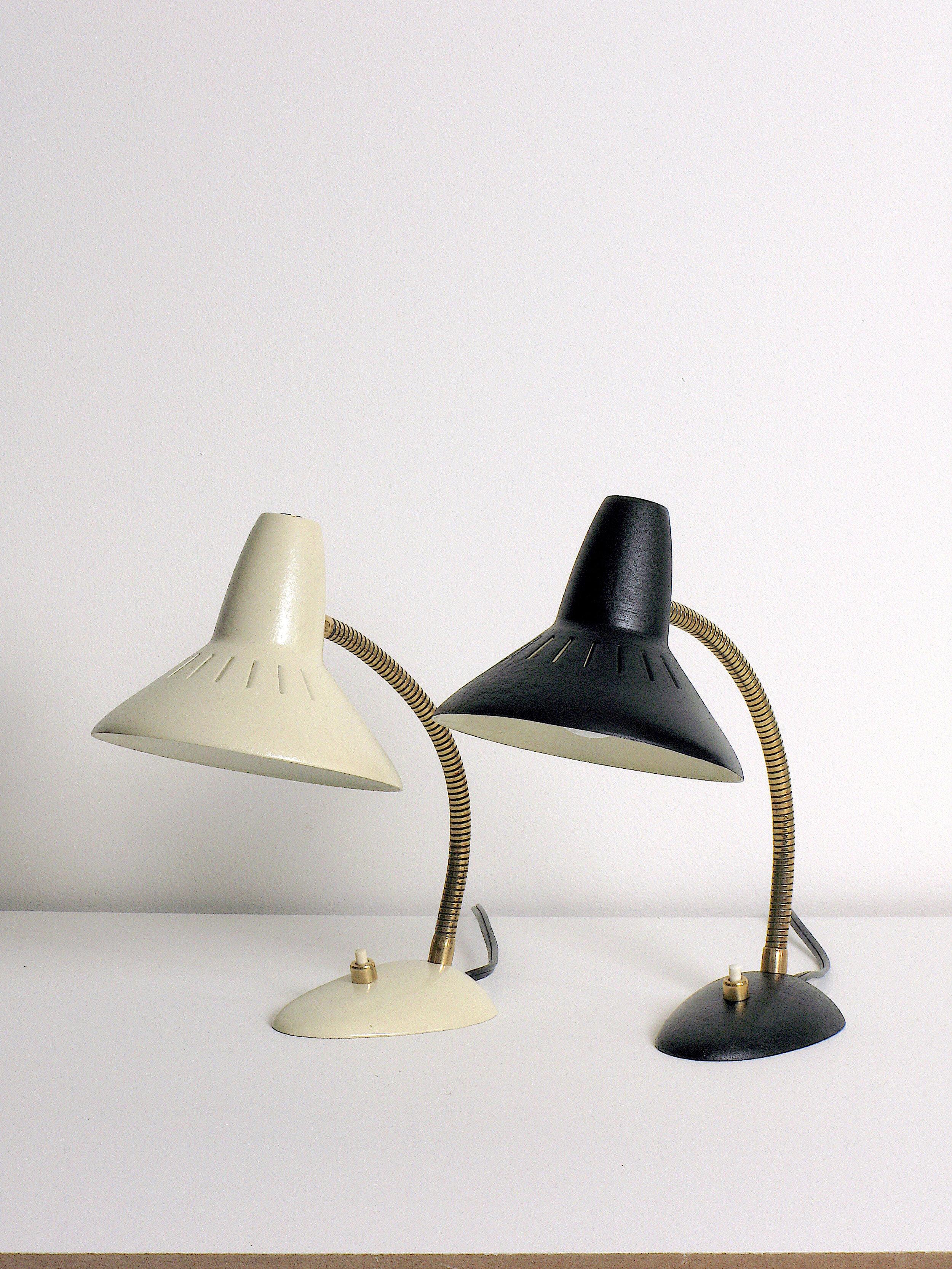 Pair of petite German desk lamps. Enameled vented steel shades, brass gooseneck, enameled steel base. 40 watts max G-16.5 candelabra incandescent bulbs recommended or higher if LED/CFL.

Rewired with a E-12 candelabra base socket, 18/2 black plastic