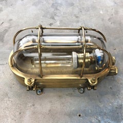 1950s German Reclaimed Industrial Cast Brass and Glass Oval Bulkhead with Cage