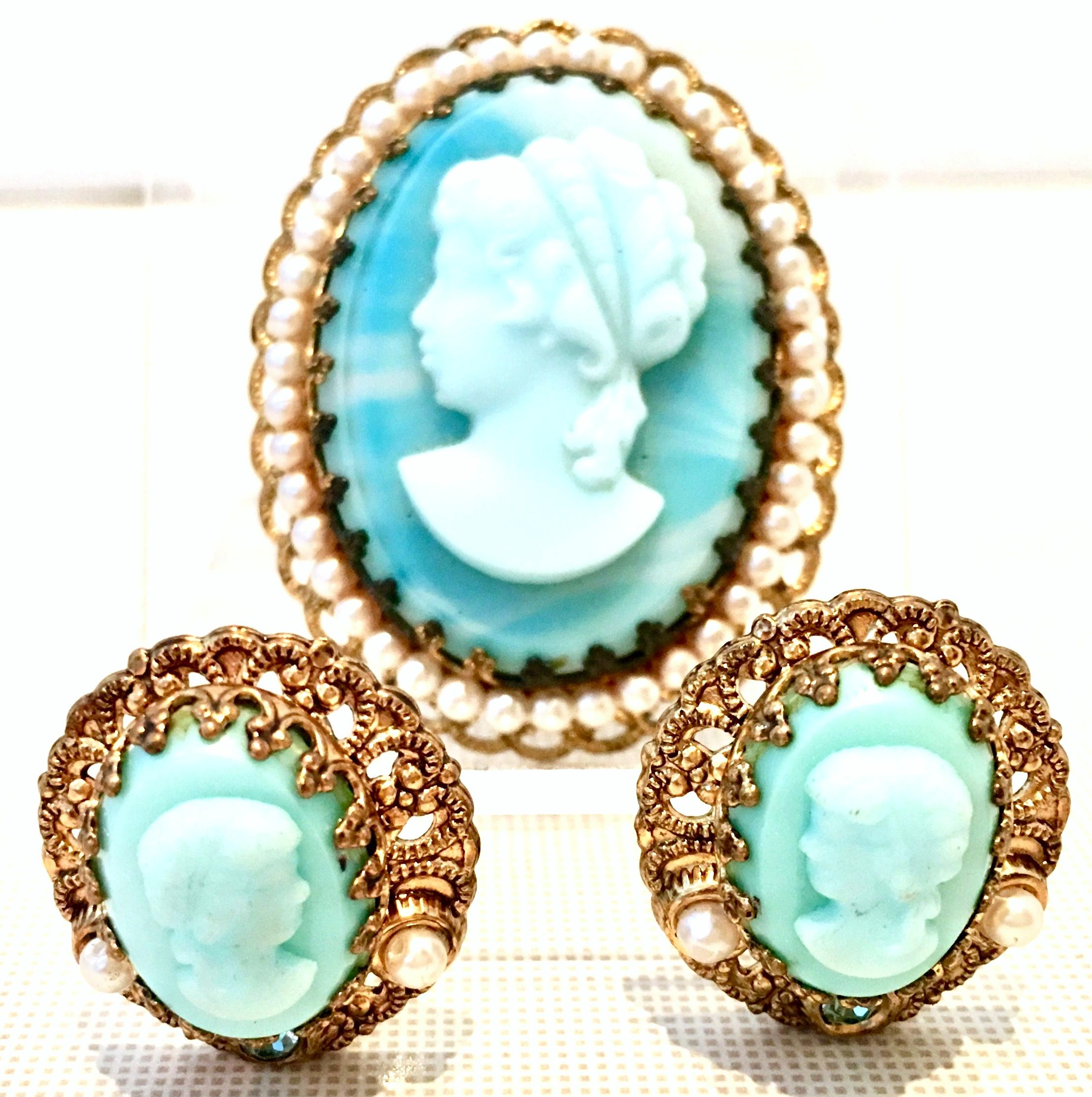 1950'S Germany, gold plate carved robins egg blue glass and faux pearl bead demi-parure brooch and earrings set. This three piece set features a left facing girl carved glass cameo, prong set in gold plate filigree with faux pearl bead surround. The