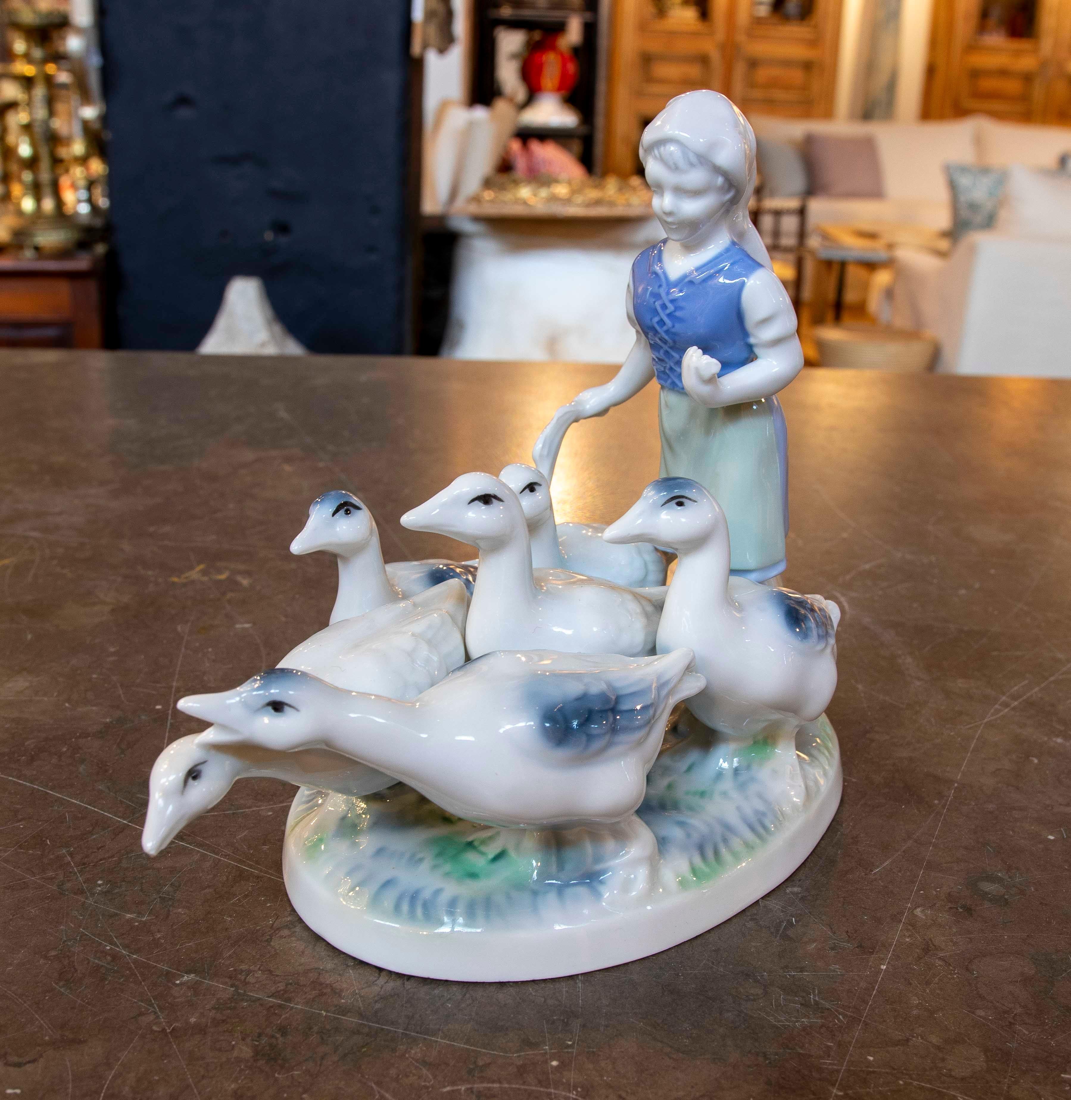 Charming porcelain figure by Gerold Porzellan Bavaria, West Germany, depicting a young shepherdess tending to a group of geese. This piece, crafted between the 1950s and 1970s, reflects traditional German style with impeccable detailing in the