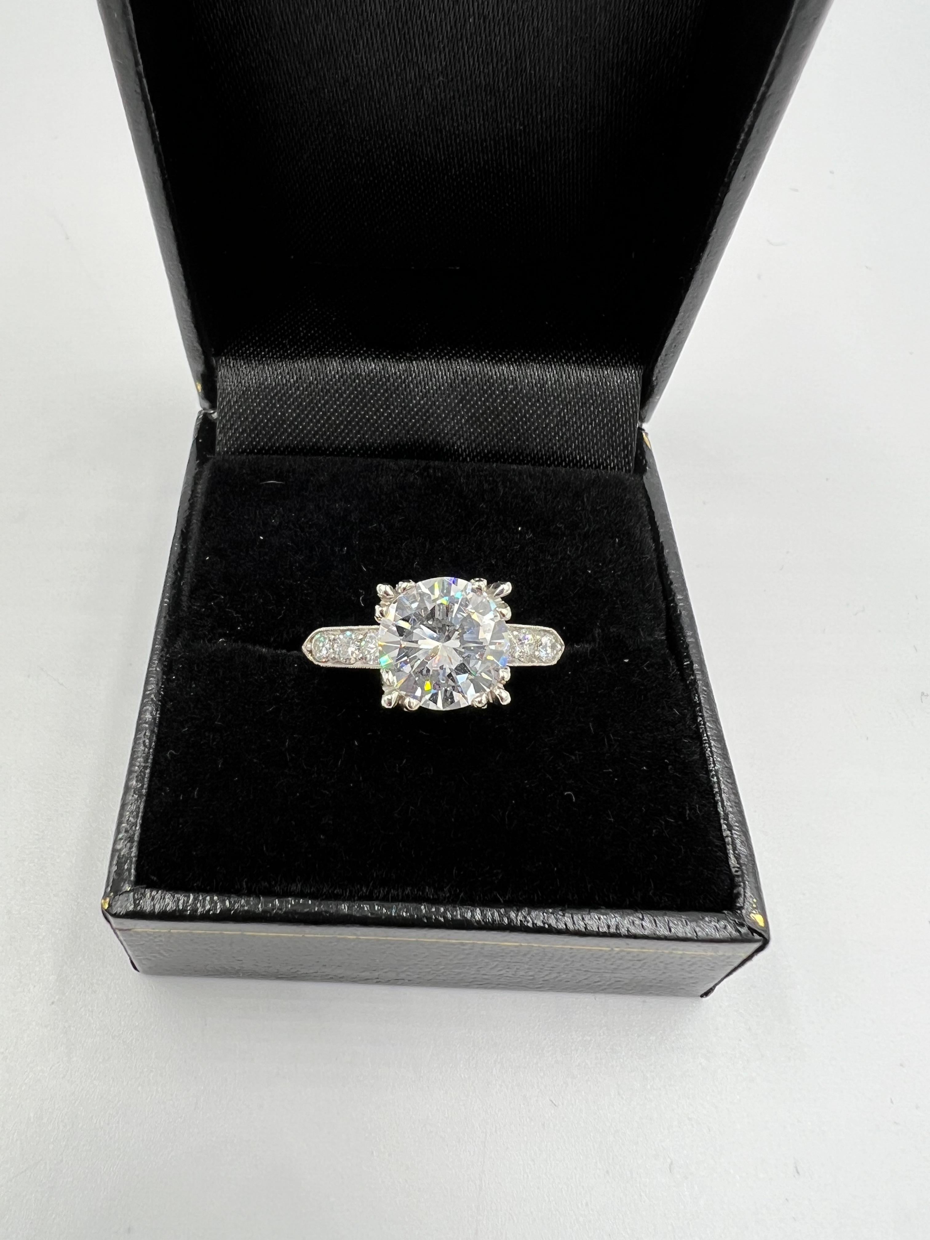 Vintage GIA 2.42 carat diamond platinum engagement ring, circa 1950s.

The Vintage GIA 2.42 Carat Diamond Platinum Engagement Ring is a timeless piece of jewelry that exudes elegance and sophistication. Crafted with precision and care, this stunning