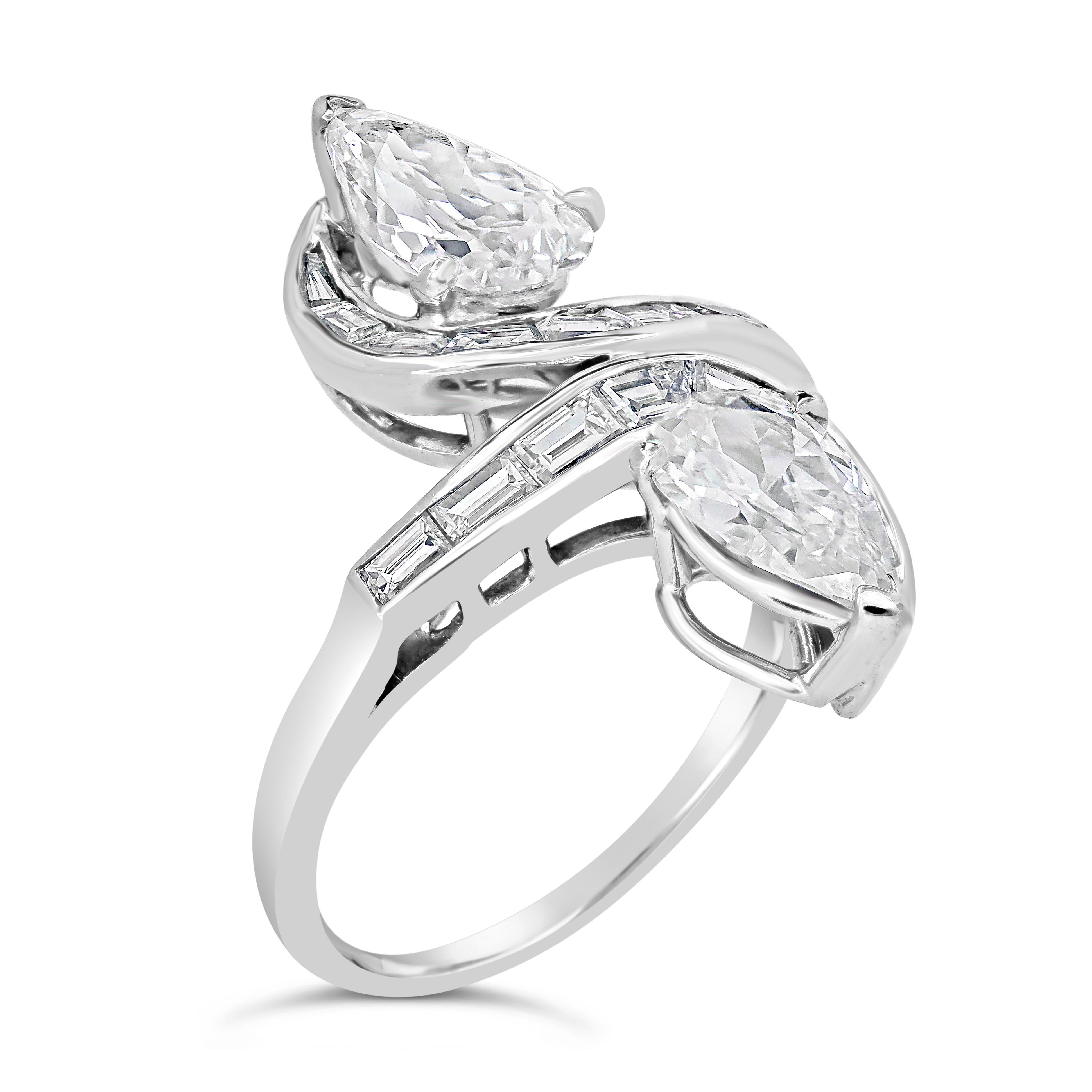 This beautiful antique cocktail ring features 2 pear shape diamonds weighing 2.48 carats total, certified by GIA as F-D Color and VS2 in Clarity. Accented by baguette cut diamonds in channel set weighing 0.90 carat total. Finely made in platinum.