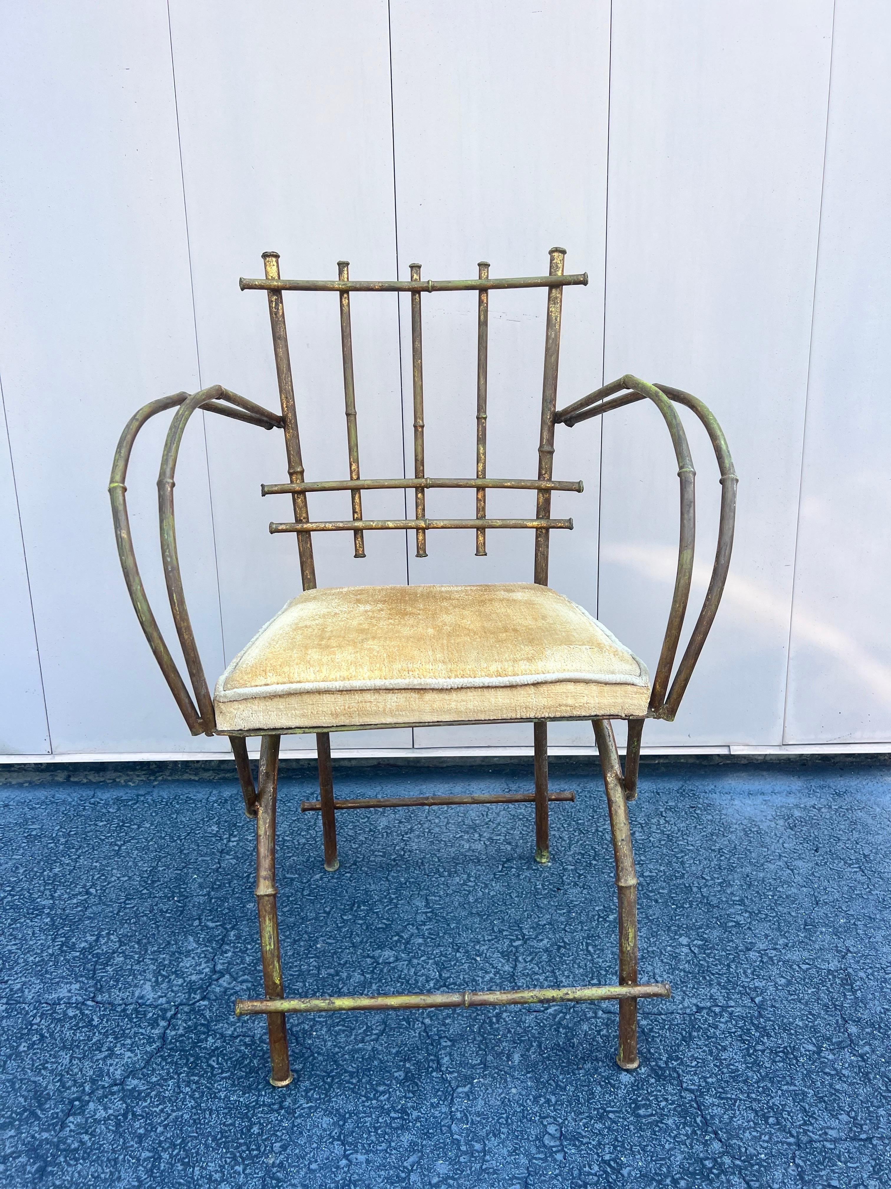 A fabulous gilt faux bamboo arm/vanity chair.   Would look great in a bedroom or dressing room.   C. 1950’s.  Produced by Hickory.   Original upholstery is gold.