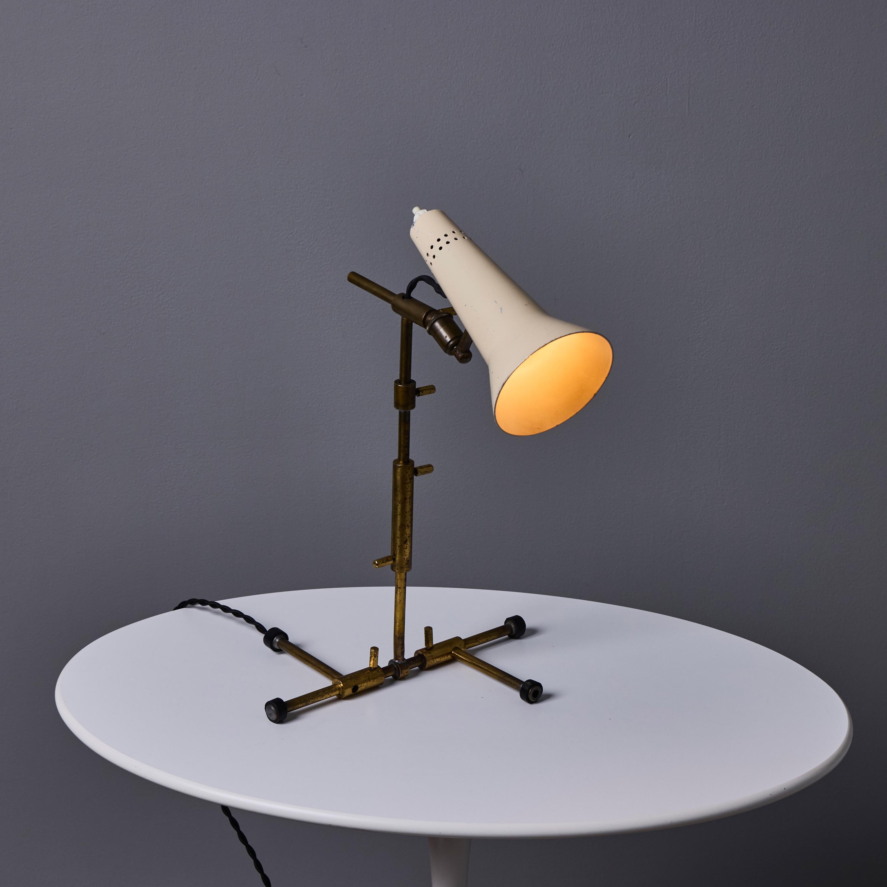 1950s Gino Sarfatti Sculptural Table Lamp for Arteluce.

Executed in a perforated white painted metal shade mounted on an adjustable patinated brass base. A highly functional and sculptural table lamp that is a quintessential example of Sarfatti's