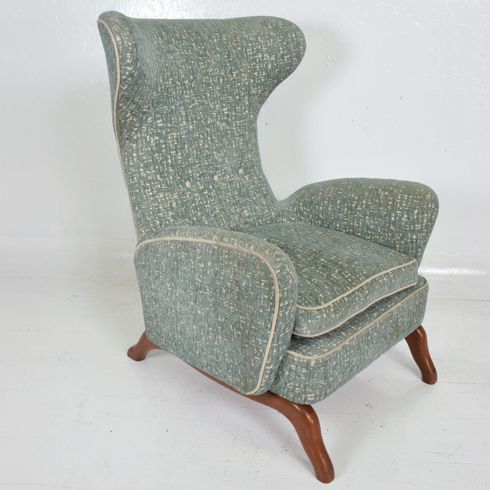 Midcentury Italian high wingback lounge armchair in the manner of Carlo Mollino and designer Gio Ponti.
Made in Italy 1950s.
Sculptural shape with solid mahogany angular legs. Upholstery is light sage green with grey.
Comfortable down feather