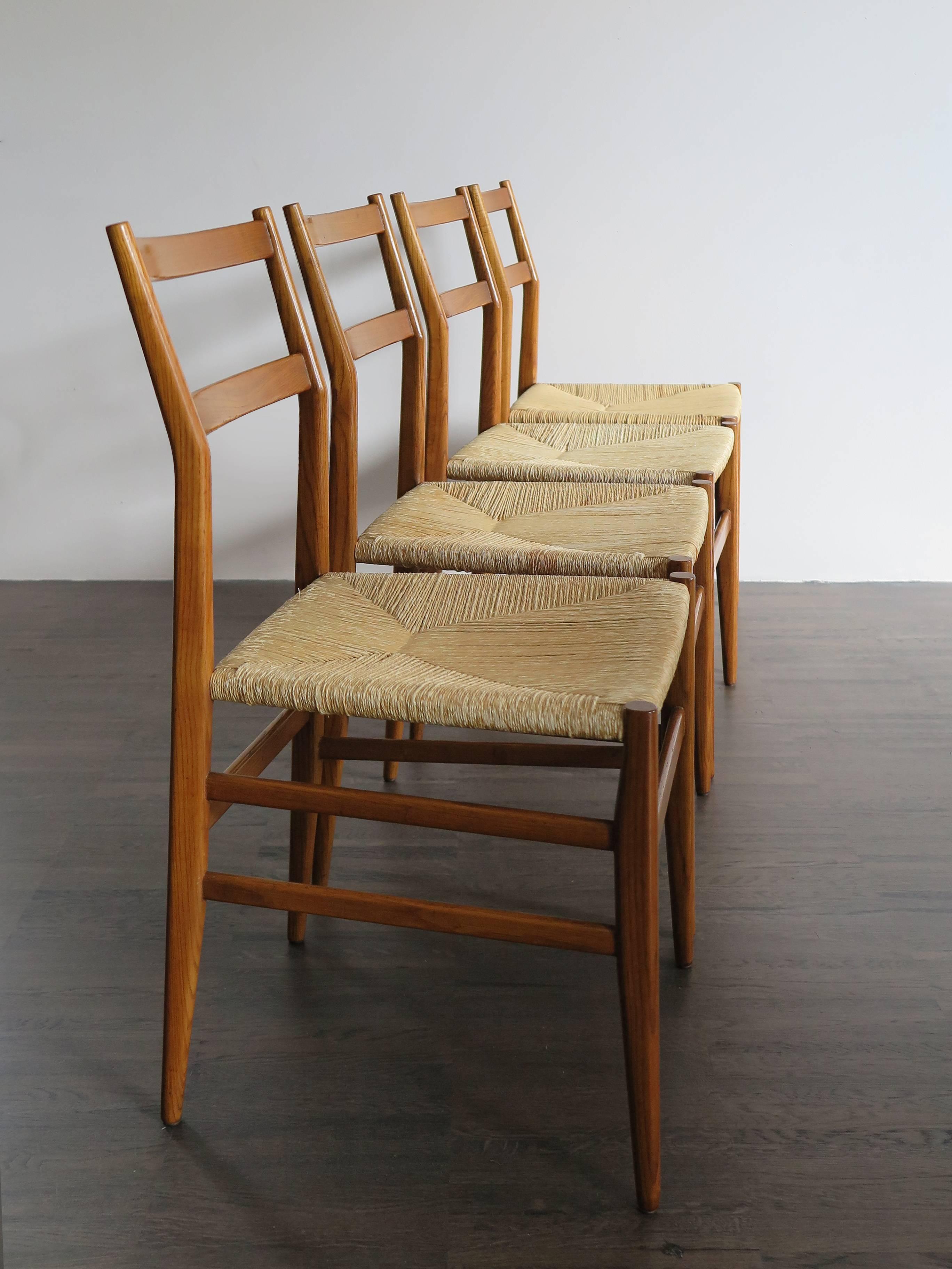 1950s four dining chairs model Leggera designed by Gio Ponti for Cassina,
ash structure and raffia seat.
