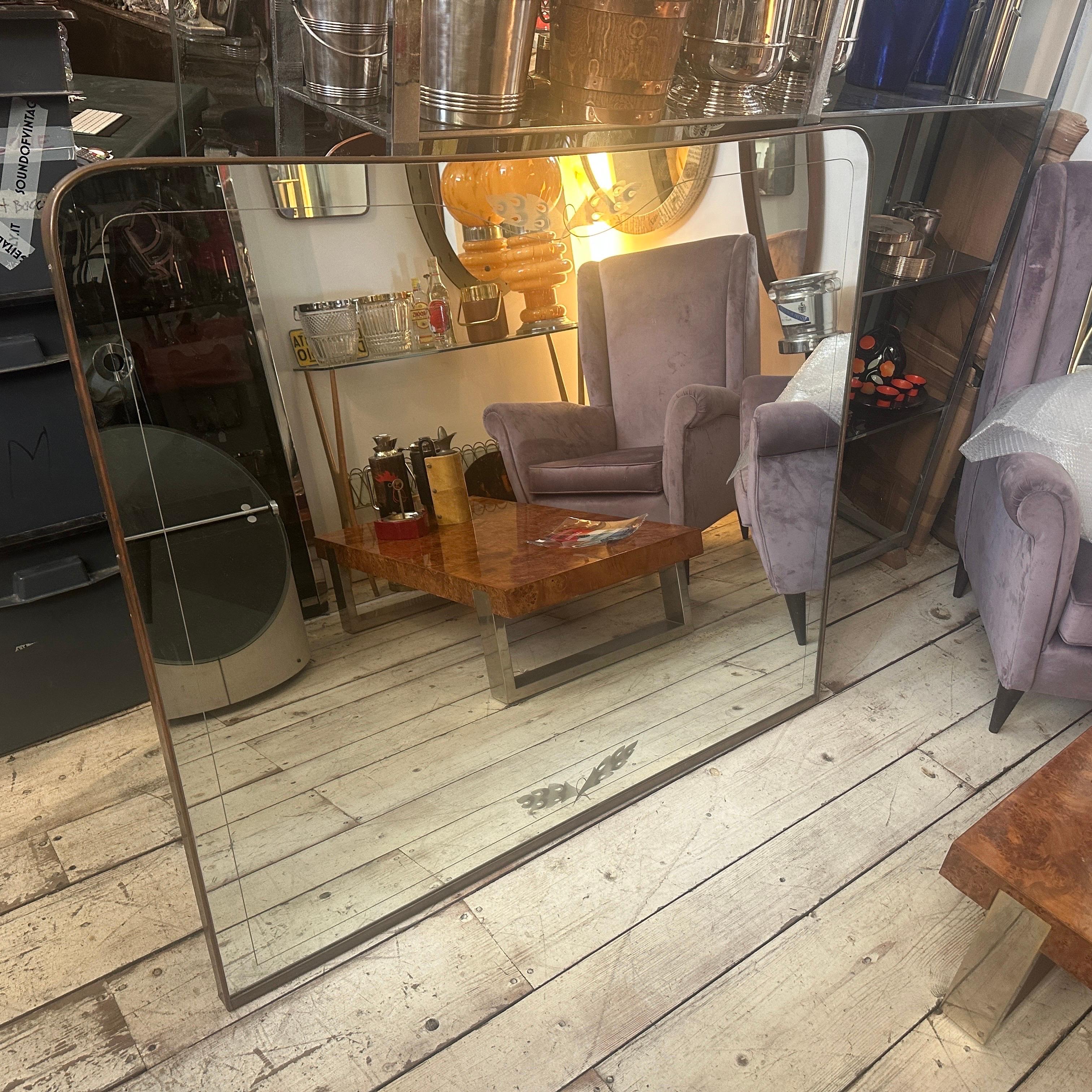 This is a magnificent, large-scale Mid-Century Modern wall mirror from the 1950s, crafted in the sophisticated style of Italian master designer Gio Ponti who used these mirrors for the most important houses in Milano.
It features a striking, simple