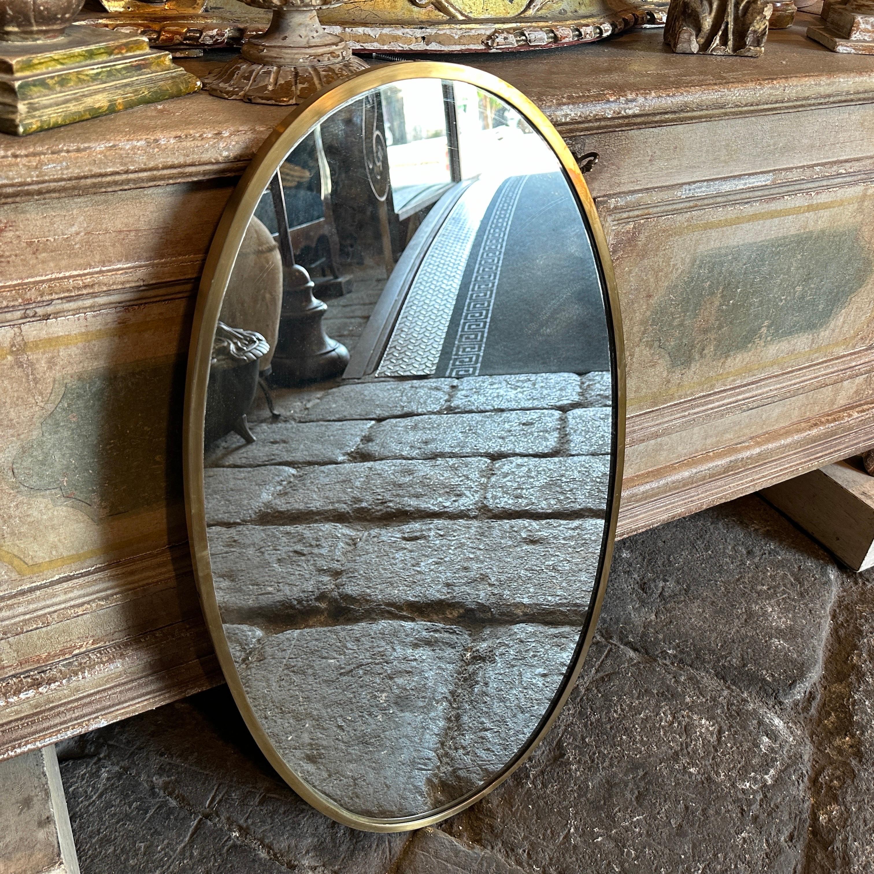 Ein massiver Messing-Wandspiegel entworfen und hergestellt in Italien in den fünfziger Jahren, Messing ist es in der ursprünglichen Patina und hat Anzeichen von Gebrauch und Alter, Spiegelglas ist das Original. Die 1950er Jahre waren eine Zeit