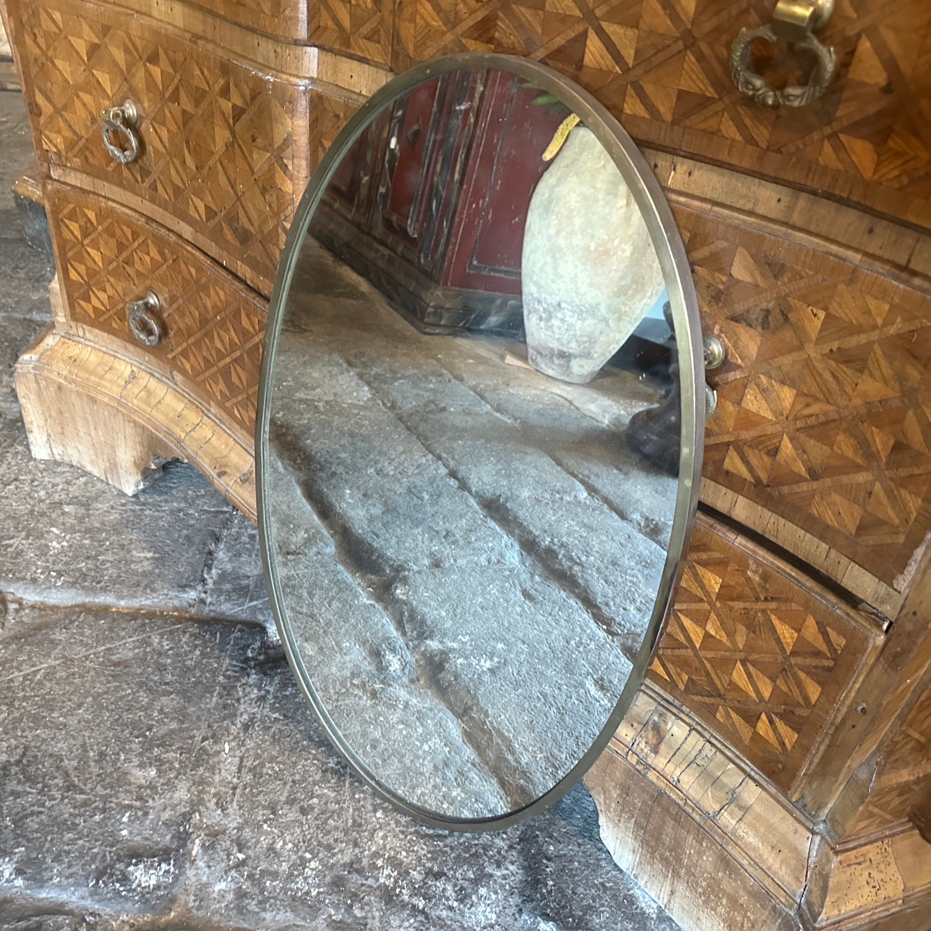 A solid brass wall mirror designed and manufactured in Italy in the Fifties, brass it's in original patina and has signs of use and age, mirror glass is the original one. The 1950s was a period of great creativity and innovation in the world of