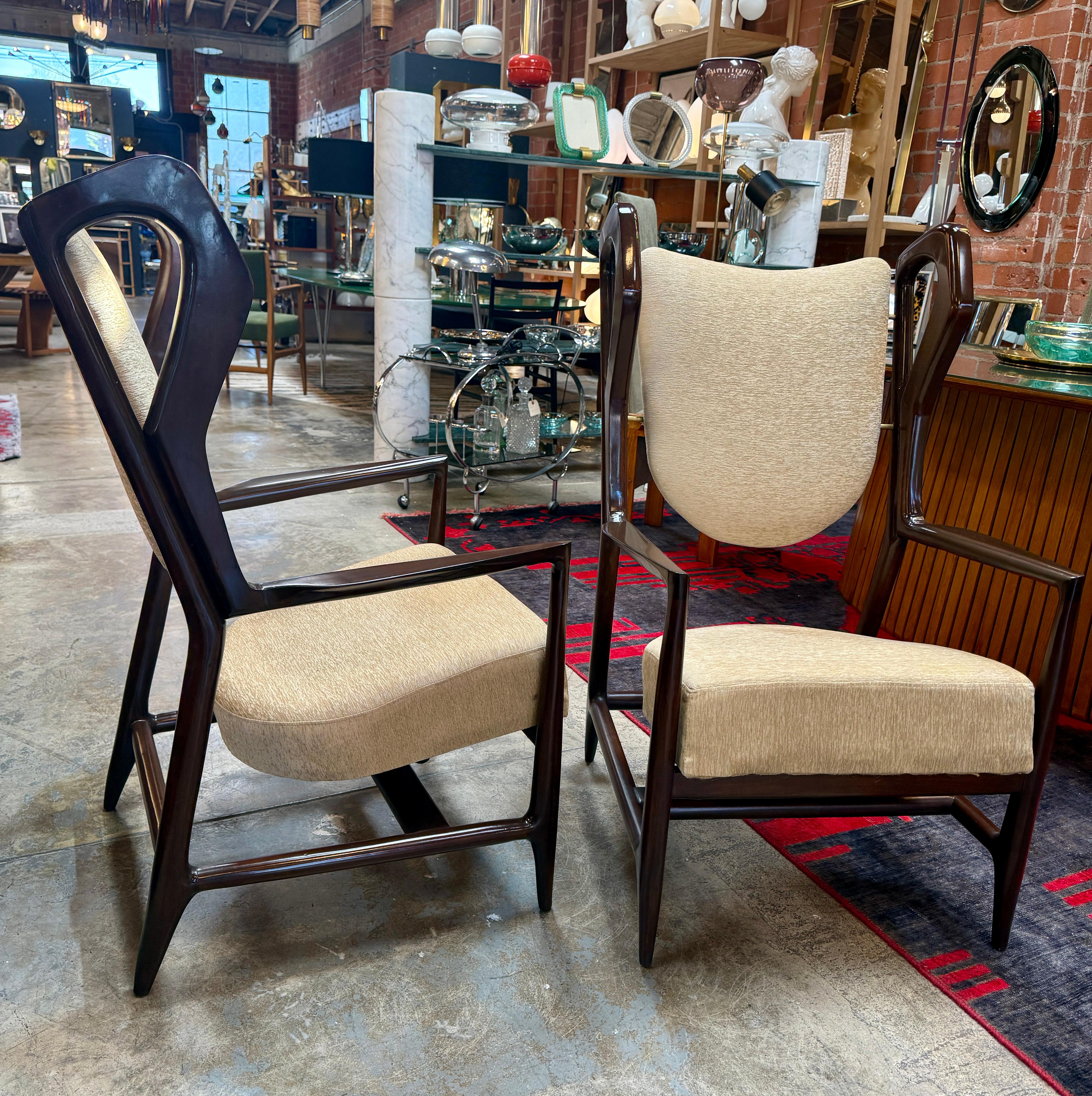 An extraordinary pair of “Triennial” armchairs by Gio Ponti, designed and crafted in Italy during the early 1950s. These very rare chairs exemplify Ponti’s ability to merge architectural rigor with sculptural elegance. The dark-stained wood frames