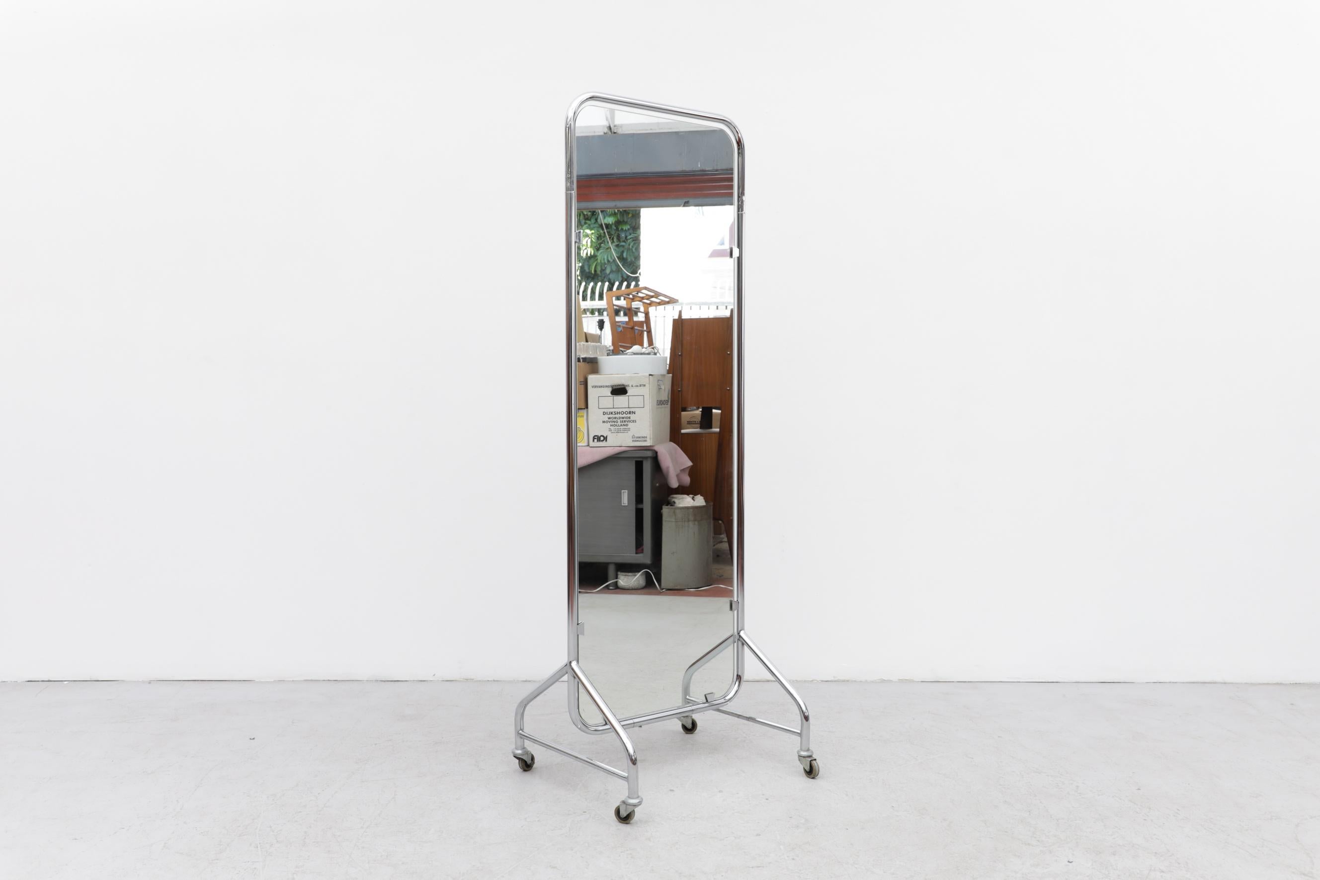 Vintage Gispen thick tubular chrome framed full length rolling mirror with original wheels and side bar frame support. In original condition with visible scratching and wear to the frame and mirror. The mirror has visible discoloration and patina