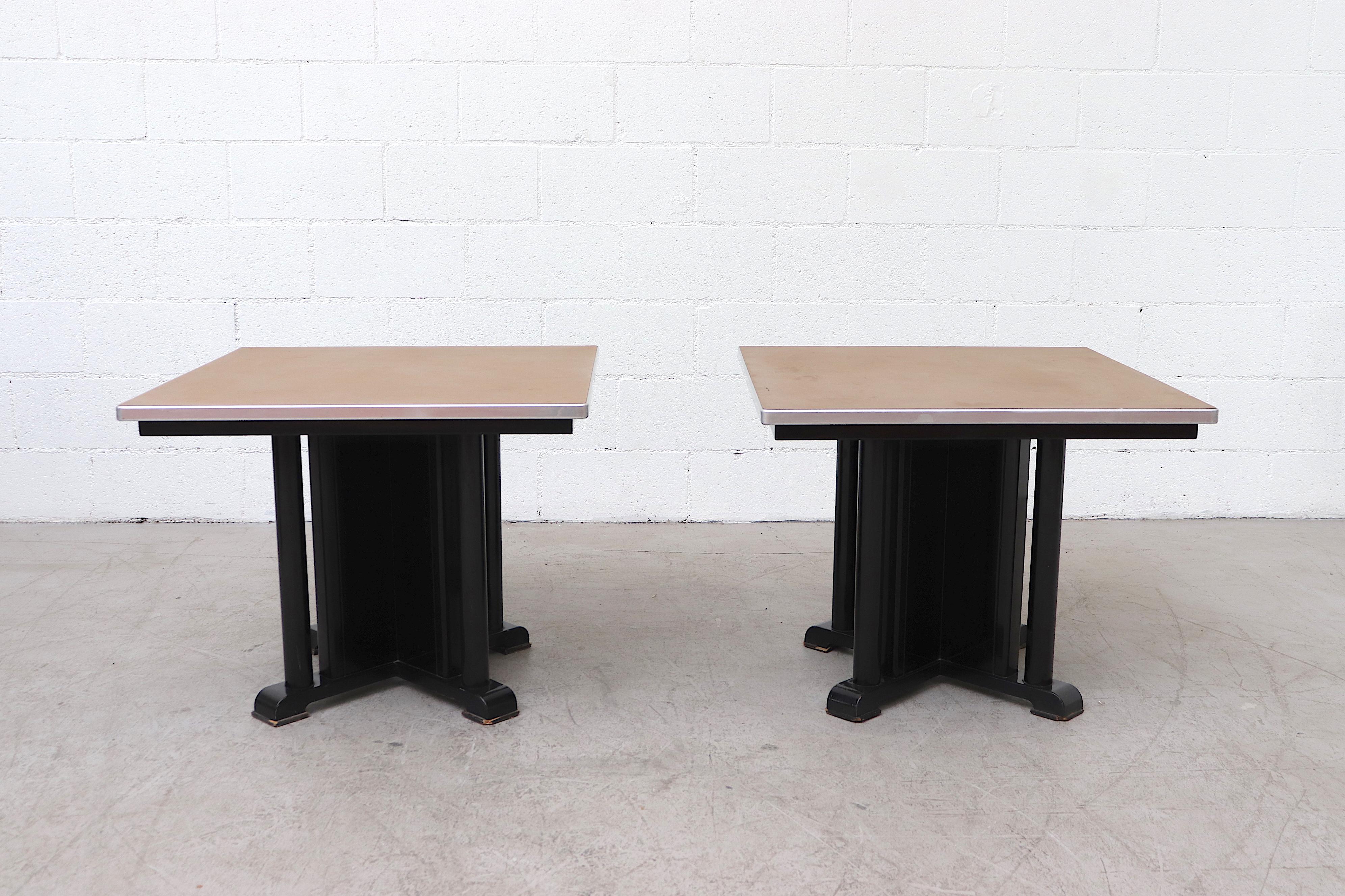 Midcentury gispen industrial side tables with black enameled metal frame and linoleum top with aluminum trim accent and painted wood foot pads. In very original condition and visible wear and scratches, including denting and impressions to the