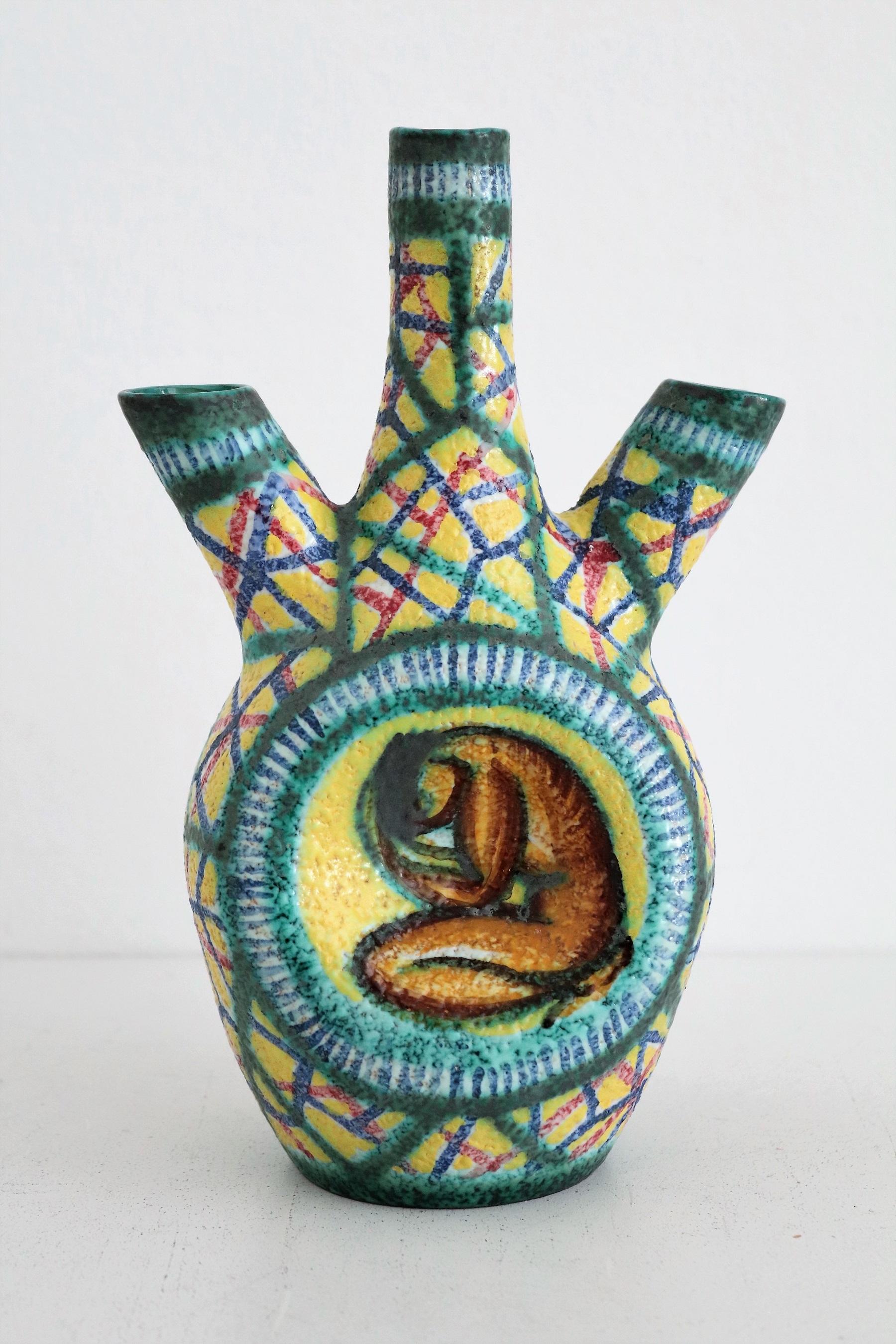 Gorgeous and rare polychrome pottery vase in bizzarre shape.
Made in the pottery manufactury from Giuseppe Barile in Albisola, Italy.
The vase is hand-crafted and hand-painted in beautiful bright colors.
The manufactury was founded in 1950, and