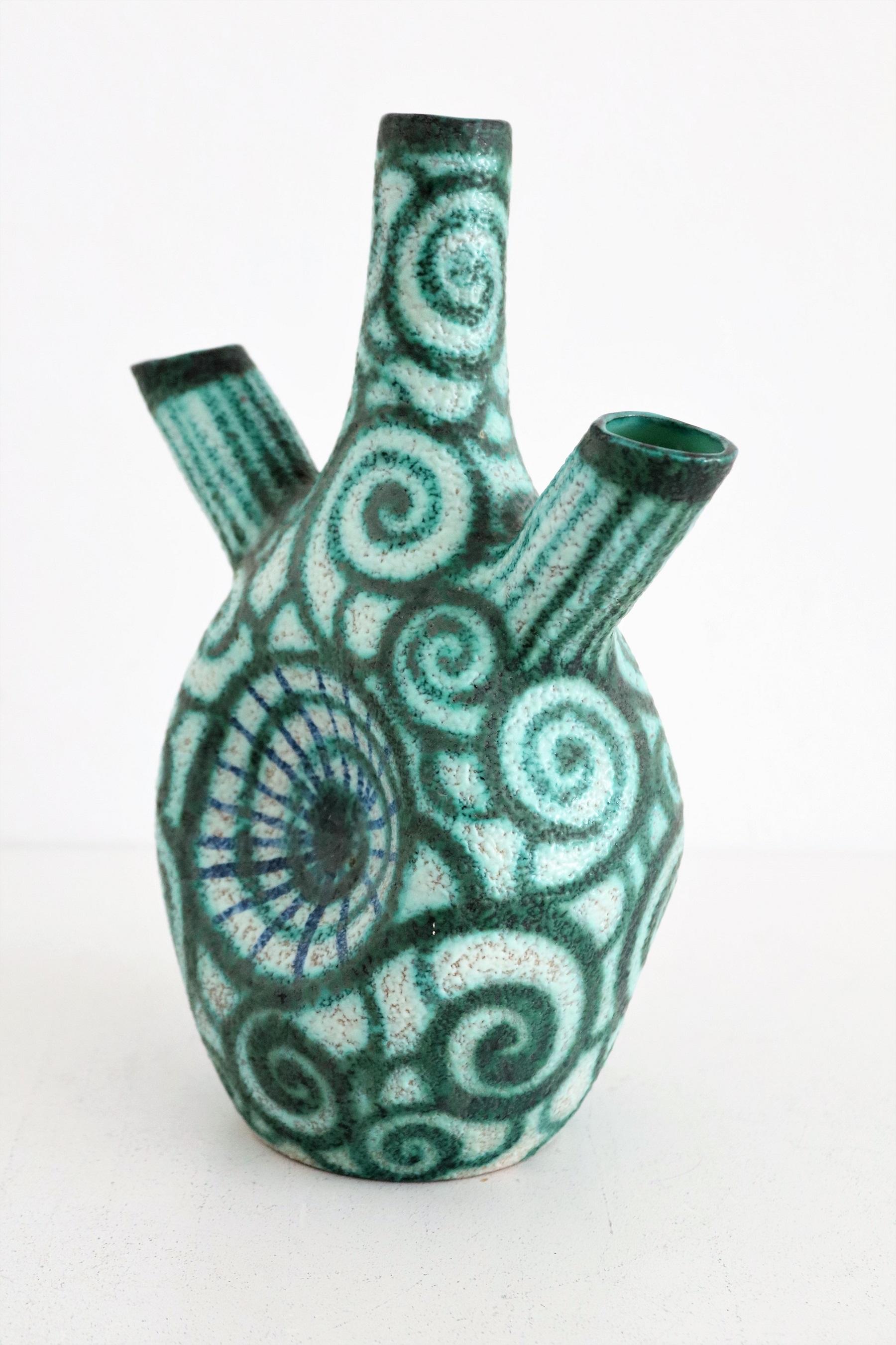 Gorgeous and rare polychrome pottery vase in bizzarre shape.
Made in the pottery manufactury from Giuseppe Barile in Albisola, Italy.
The vase is hand-crafted and hand-painted in beautiful bright colors.
The manufactury was founded in 1950, and