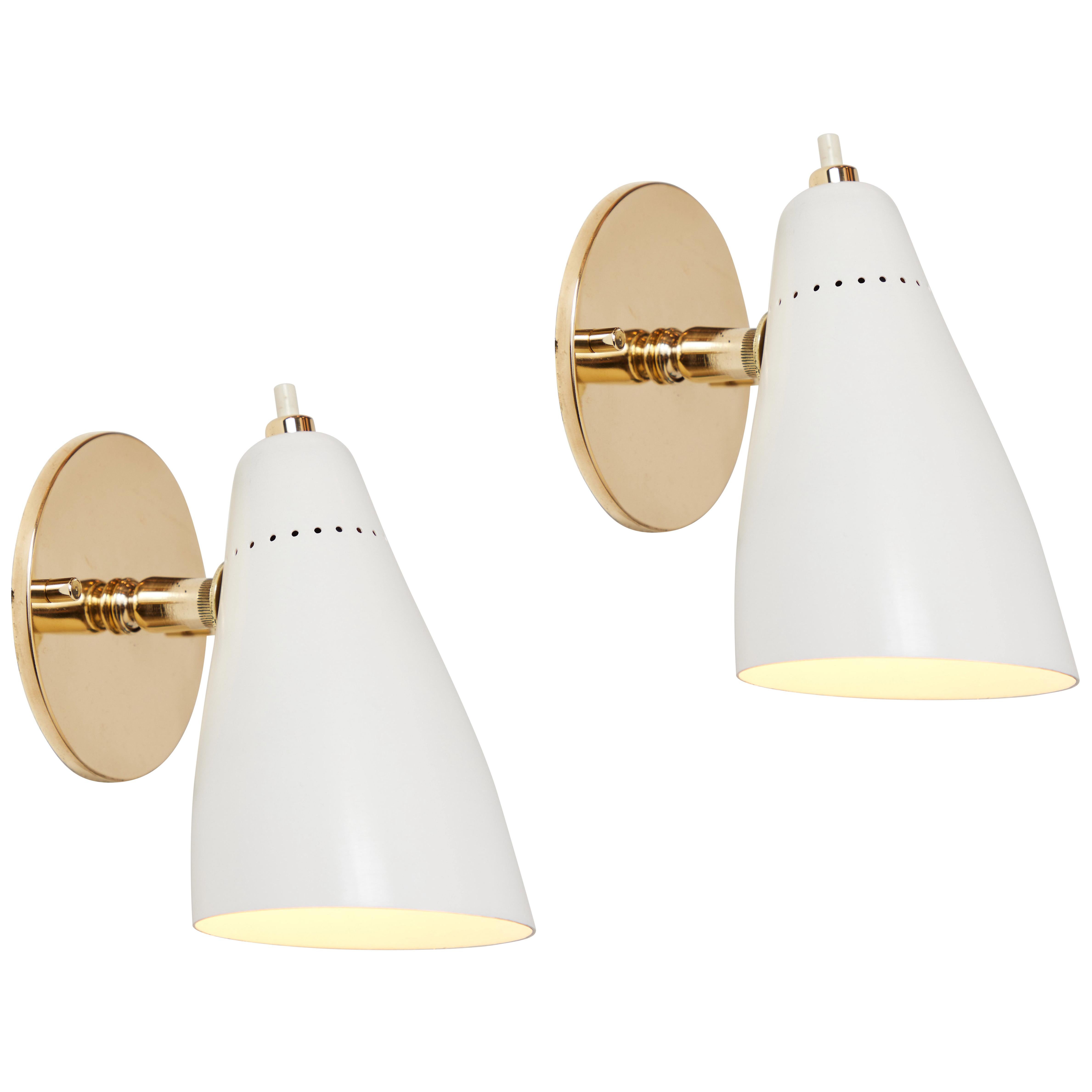 1950s Giuseppe Ostuni white articulating sconces for O-Luce. Executed in brass and white painted aluminum with perforated shade. Sconces pivot up/down and left/right. 

Price is per item. Four lamps available.

Original on/off switch on top of