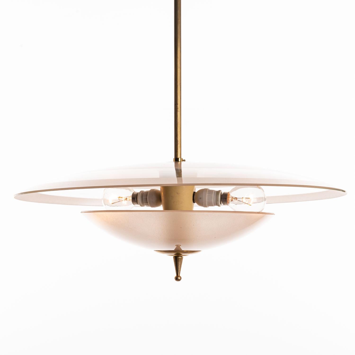 This elegant piece consisting of a brass frame and 2 unique frosted and satin glass reflector/saucers. 
The lower round curved pink-ish glass reflector mounts below a round pinkish & clear glass dish. In the center 2 electrical E14 sockets. Brass